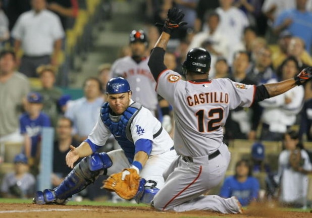 LOS ANGELES, CA - JULY 30:   Jose Castillo #12 of the San Francisco Giants is out at home plate in the final play of the 9th inning against Russell Martin #55 of the Los Angeles Dodgers at Dodger Stadium on July 30, 2008 in Los Angeles, California.  The D