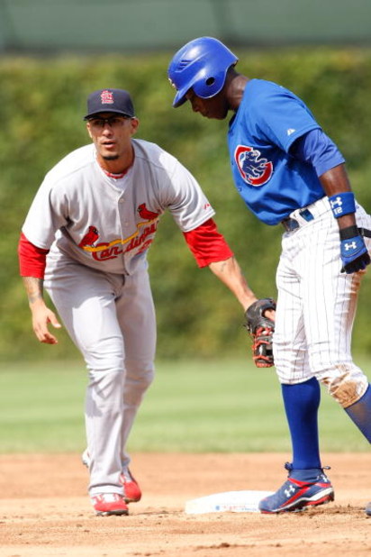 CHICAGO, IL - SEPTEMBER 19: Outfielder Alfonso Soriano #12 of the Chicago Cubs is tagged by second baseman Felipe Lopez #22 of the St. Louis Cardinals at Wrigley Field on September 19, 2008 in Chicago, Illinois. (Photo by Scott Boehm/Getty Images)