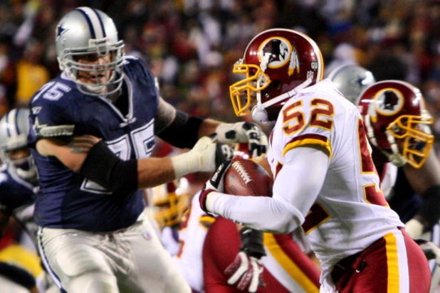 LANDOVER, MD - NOVEMBER 16:  Rocky McIntosh #52 of the Washington Redskins runs the ball against Marc Colombo #75 of the Dallas Cowboys after catching an interception during the game on November 16, 2008 at FedEx Field in Landover, Maryland.  (Photo by Ji