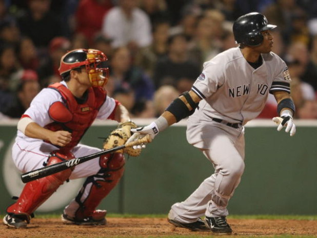 BOSTON - SEPTEMBER 26:  Robinson Cano #24 of the New York Yankees drives in two runs as Kevin Cash #30 of the Boston Red Sox catches on September 26, 2008 at Fenway Park in Boston, Massachusetts.  (Photo by Elsa/Getty Images)