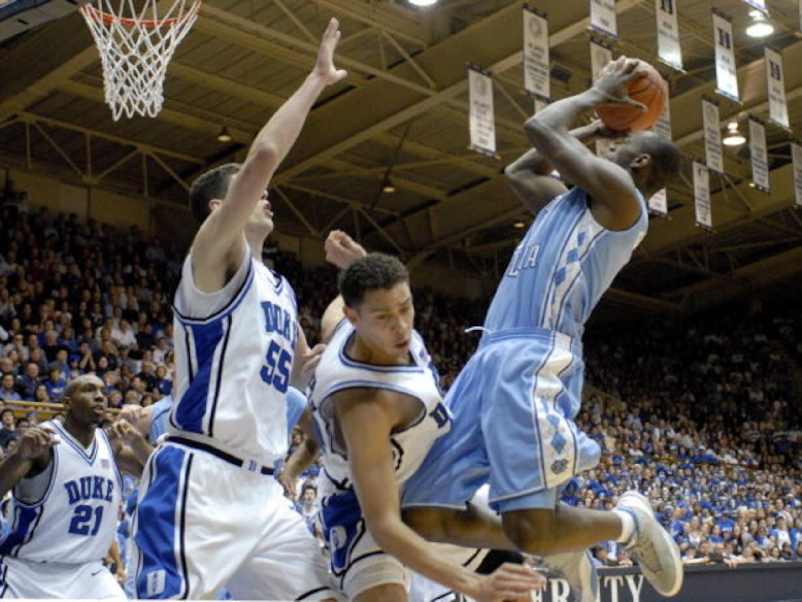DURHAM, NC - FEBRUARY 07:  David McClure #14 of the Duke University Blue Devils fouls Marcus Ginyard #1 of the North Carolina Tar Heels during their game on February 7, 2007 at Cameron Indoor Stadium in Durham, North Carolina.  (Photo by Grant Halverson/G