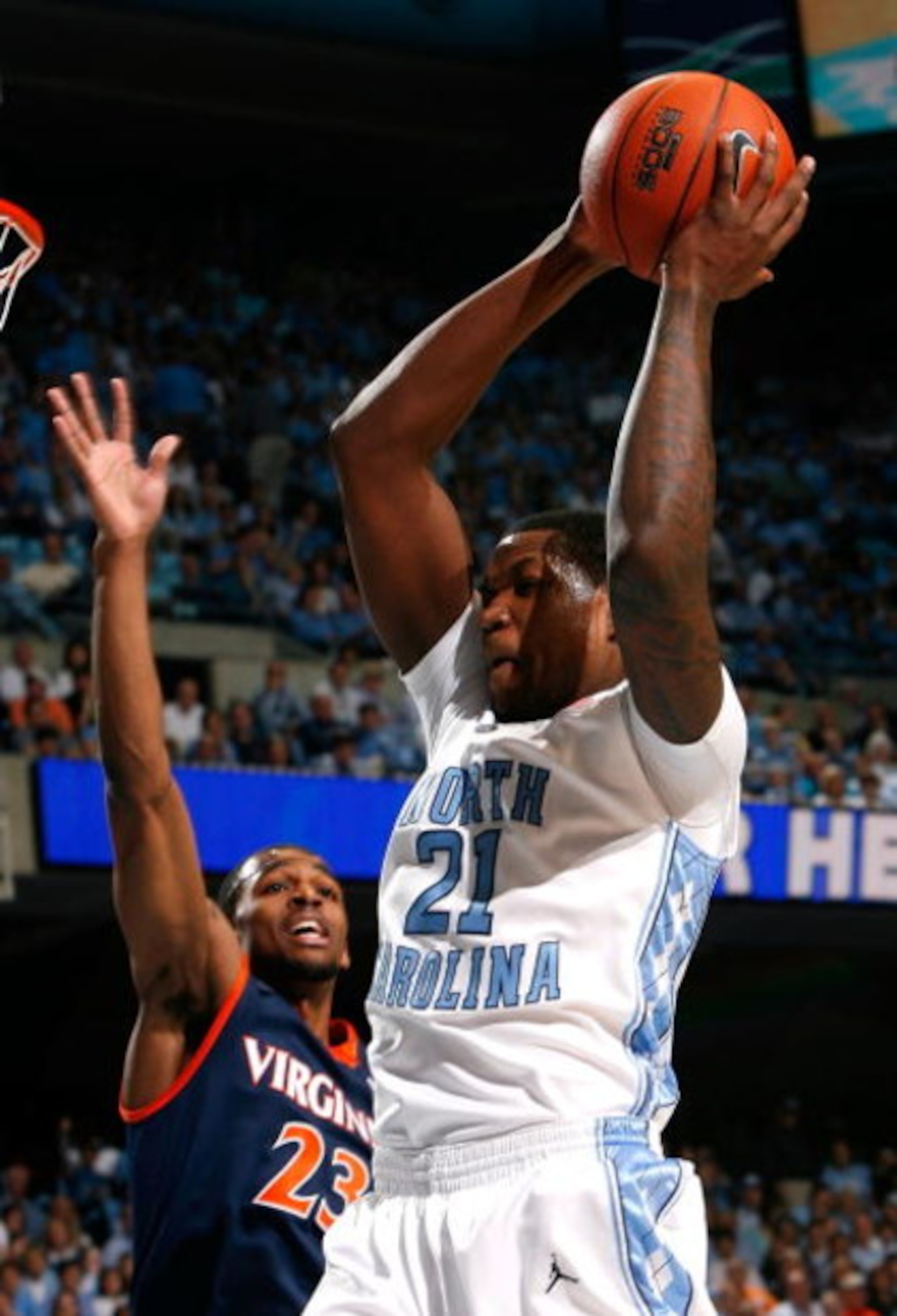 CHAPEL HILL, NC - FEBRUARY 07:  Deon Thompson #21 of the North Carolina Tar Heels grabs a rebound against Jeff Jones #23 of the Virginia Cavaliers during the game on February 7, 2009 at the Dean E. Smith Center in Chapel Hill, North Carolina.  (Photo by K