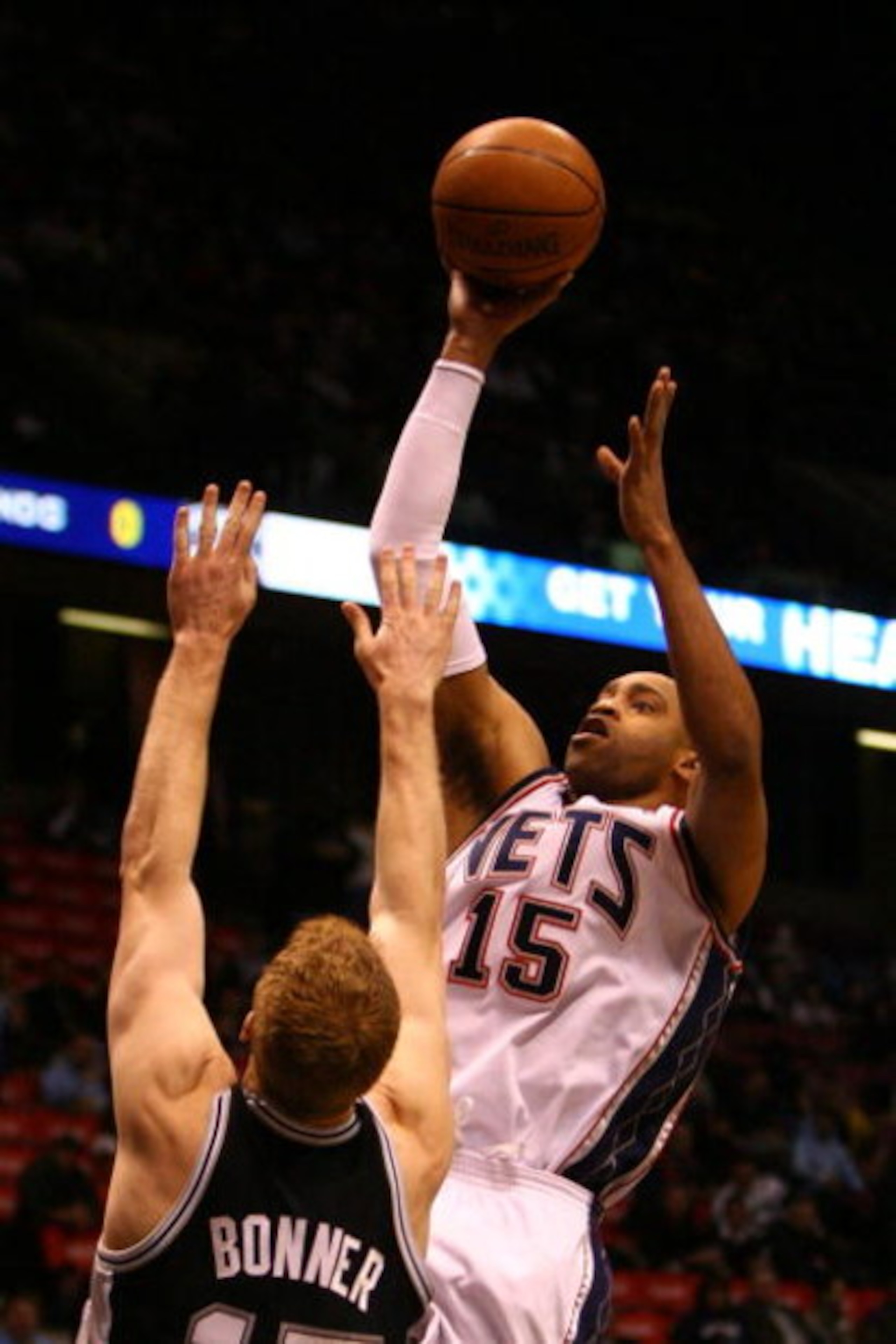 EAST RUTHERFORD, NJ - FEBRUARY 10:  Vince Carter #15 of the New Jersey Nets drives to the basket against Matt Bonner #15 of the San Antonio Spurs during their game on February 10, 2009 at The Izod Center in East Rutherford, New Jersey.  NOTE TO USER: User
