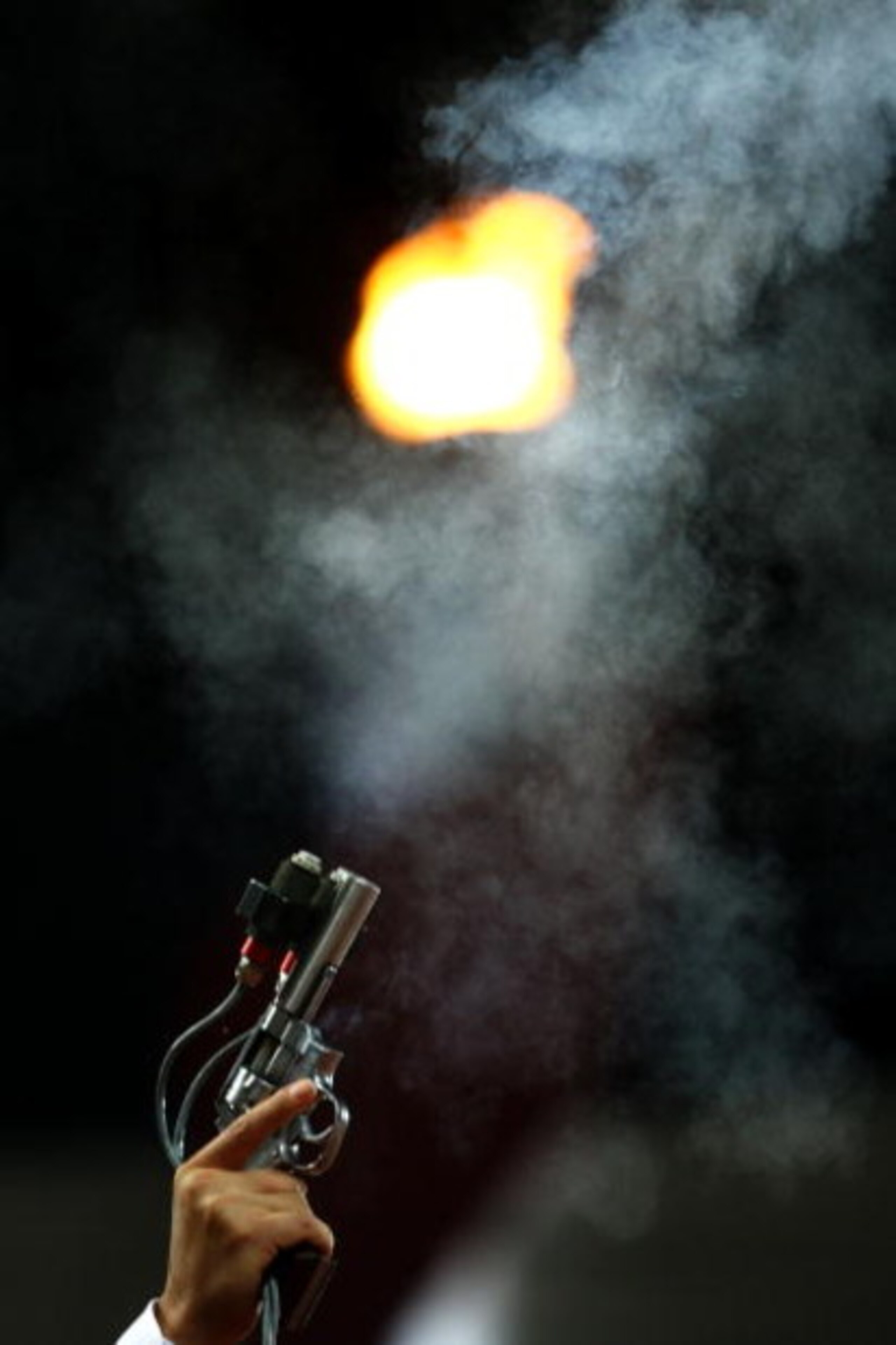 BEIJING - AUGUST 23:  The starters pistol fires in front of the Olympic Flame held at the National Stadium on Day 15 of the Beijing 2008 Olympic Games on August 23, 2008 in Beijing, China.  (Photo by Julian Finney/Getty Images)