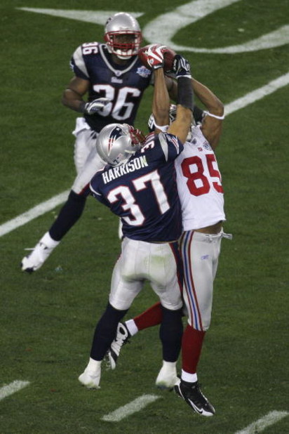 GLENDALE, AZ - FEBRUARY 03:  David Tyree #85 of the New York Giants catches a 32-yard pass from Eli Manning #10 as Rodney Harrison #37 of the New England Patriots attempts to knock it out in the fourth quarter of Super Bowl XLII on February 3, 2008 at the