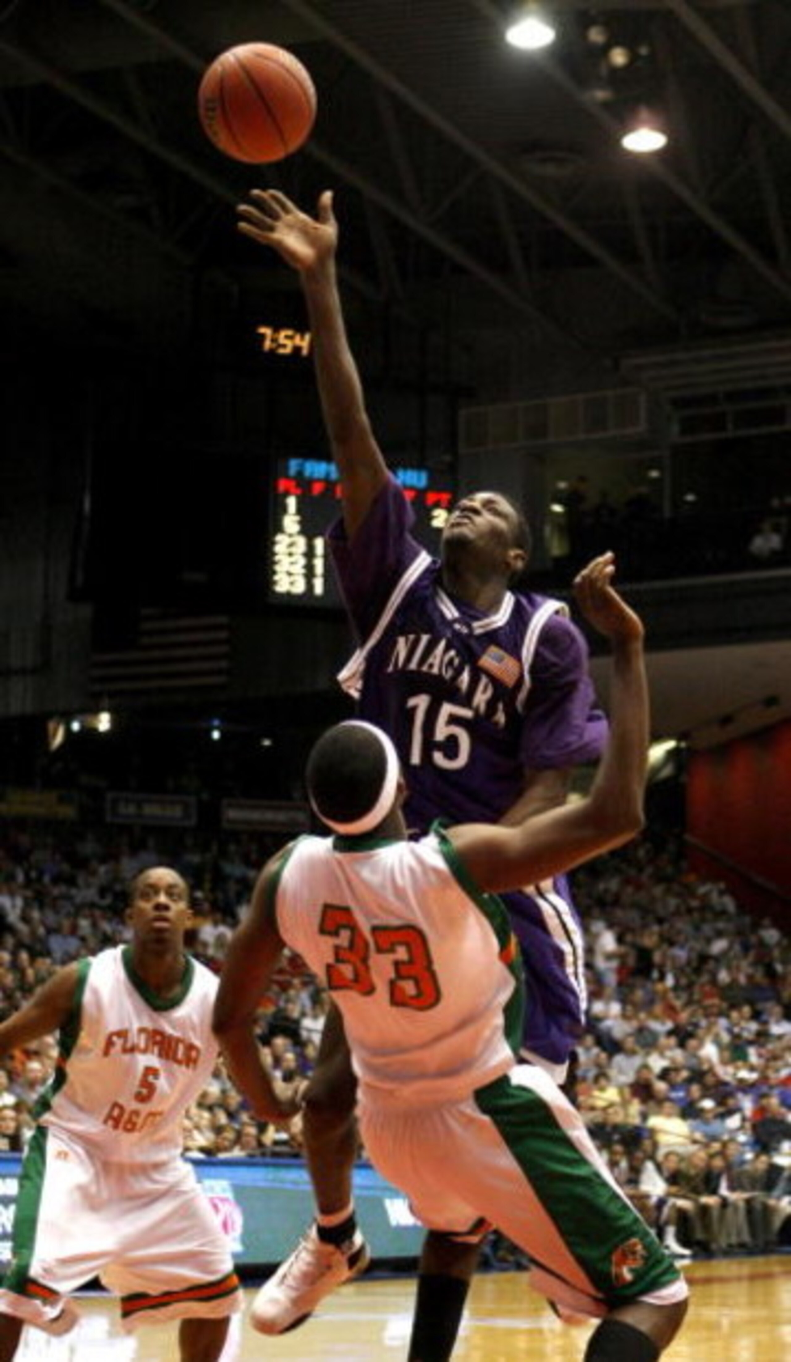 DAYTON, OH - MARCH 13: Benson Egemonye #15 of the Niagara Purple Eagles tries to get a shot off over Akini Adkins #33 of the Florida A&M Rattlers during the opening round of the Men's NCAA Tournament on March 13, 2007 at the University of Dayton Arena i DAYTON, OH - MARCH 13: Benson Egemonye #15 of the Niagara Purple Eagles tries to get a shot off over Akini Adkins #33 of the Florida A&M Rattlers during the opening round of the Men's NCAA Tournament on March 13, 2007 at the University of Dayton Arena i
