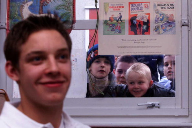 25 Jan 2001:  Alan Smith of Leeds United gives an interview to the press as the children of Middleton Primary School look through the window to get a glimpse of their hero during a Nike soccer coaching clinic held at Middleton Primary School in Leeds. Man