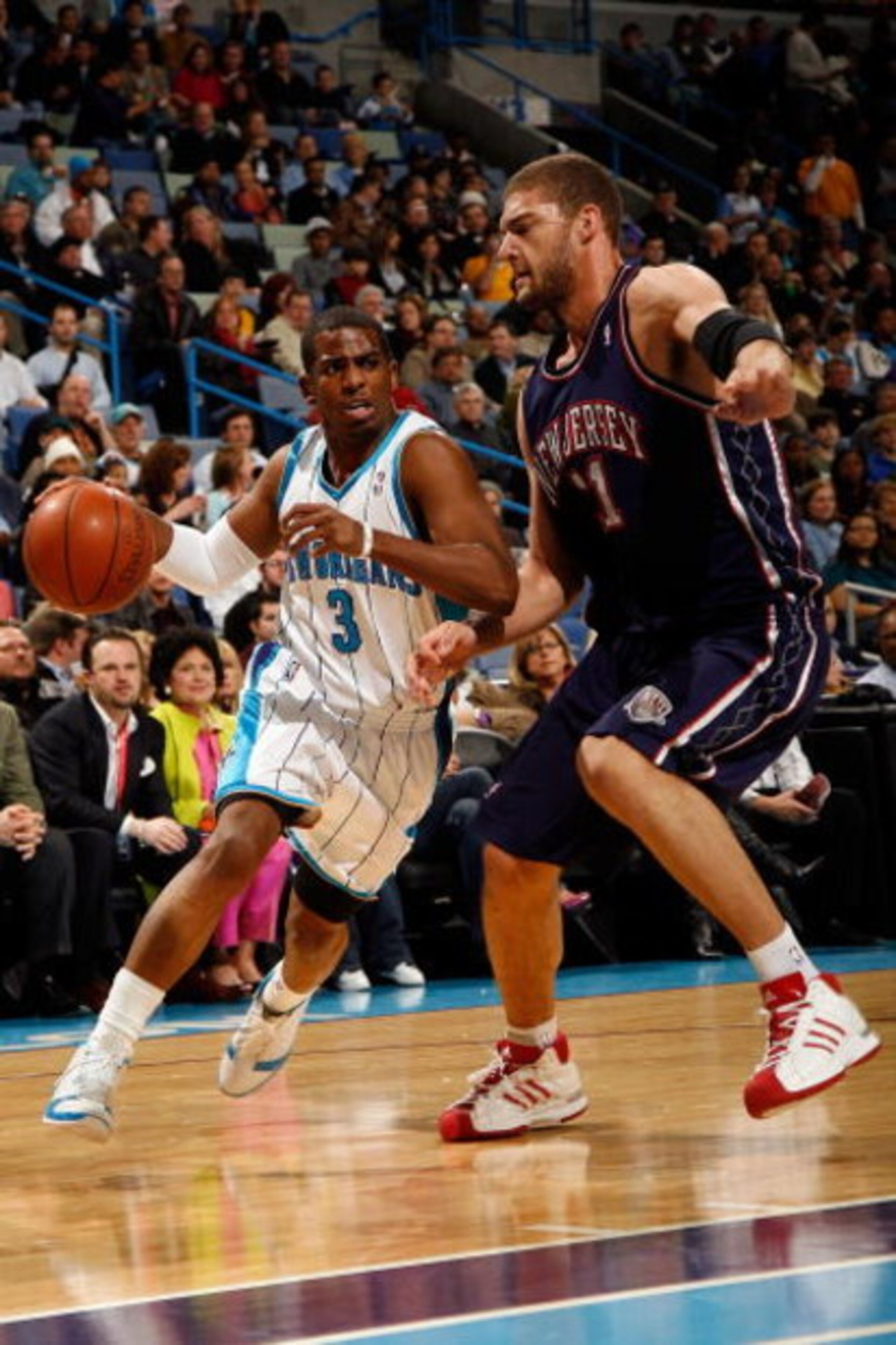 NEW ORLEANS - JANUARY 21:  Chris Paul #3 of the New Orleans Hornets drives around Brook Lopez #11 of the New Jersey Nets on January 21, 2009 at the New Orleans Arena in New Orleans, Louisiana.  NOTE TO USER: User expressly acknowledges and agrees that, by