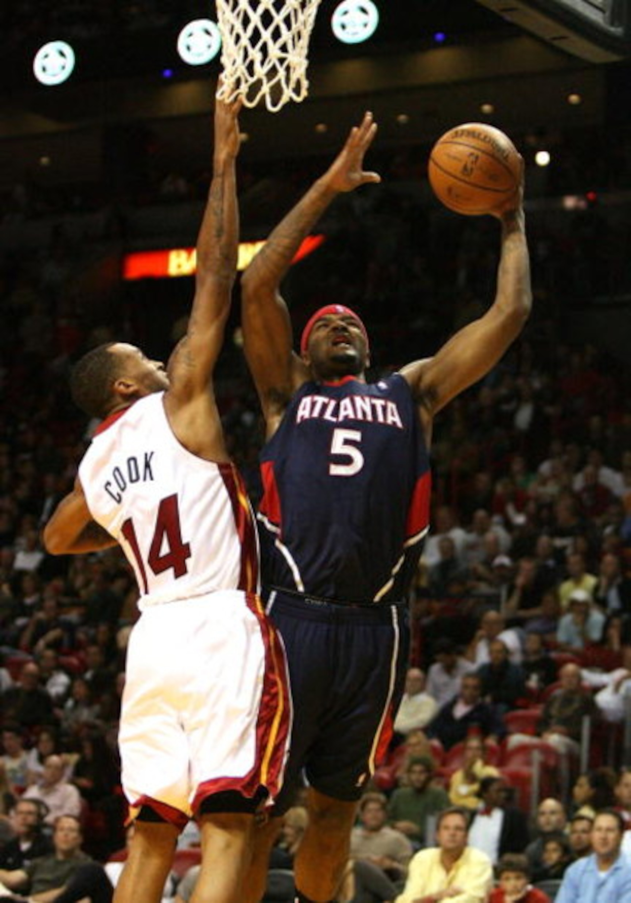 MIAMI - DECEMBER 12:  Josh Smith #5 of the Atlanta Hawks scores over Daequan Cook #14 of the Miami Heat at American Airlines Arena on December 12, 2008 in Miami, Florida. The Hawks defeated the Heat 87-73. NOTE TO USER: User expressly acknowledges and agr