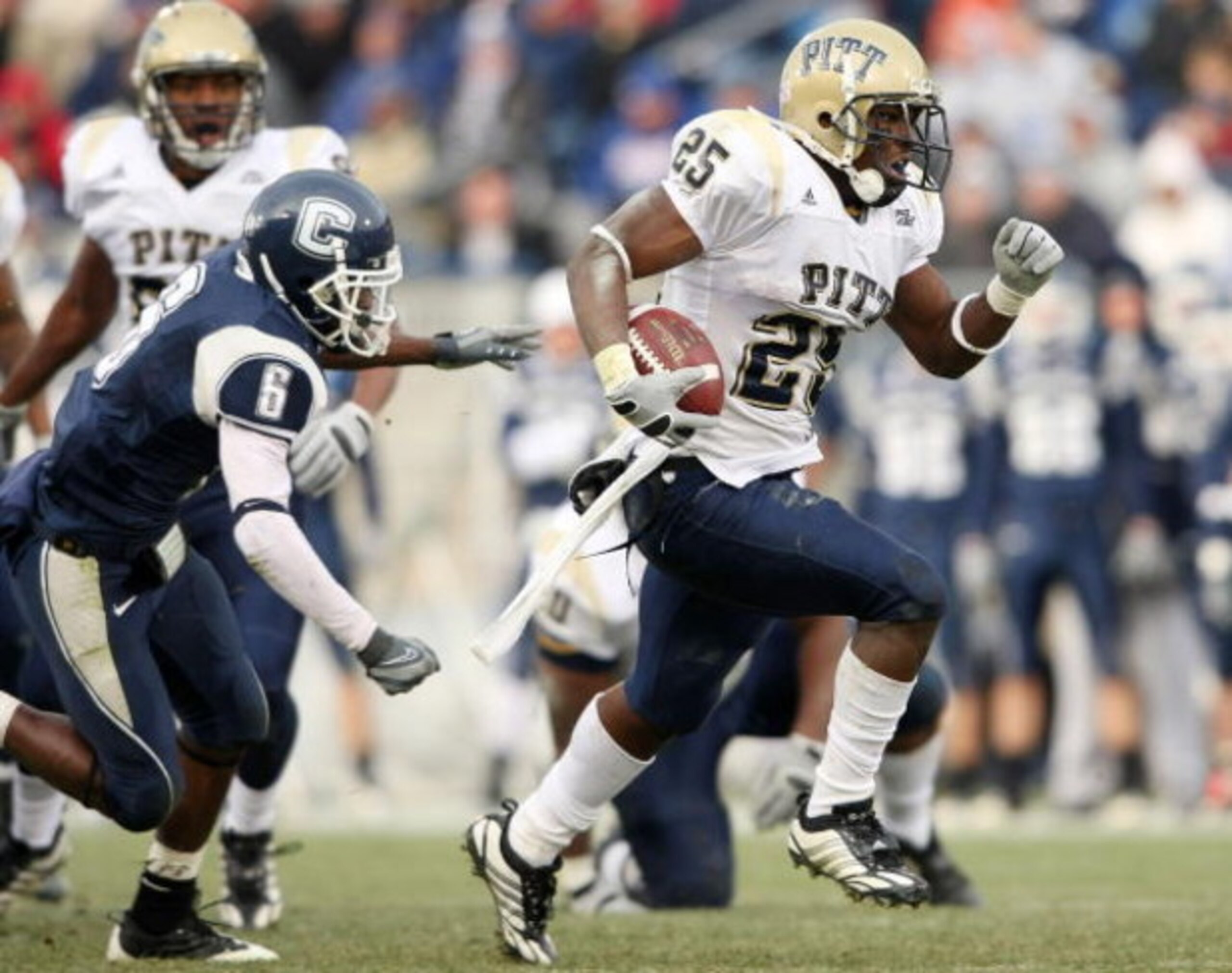EAST HARTFORD, CT - DECEMBER 06:  LeSean McCoy #25 of the Pittsburgh Panthers breaks free from Jasper Howard #6 of the Connecticut Huskies to carry the ball in for a touchdown on December 6, 2008 at Rentschler Field in East Hartford, Connecticut. The Pant