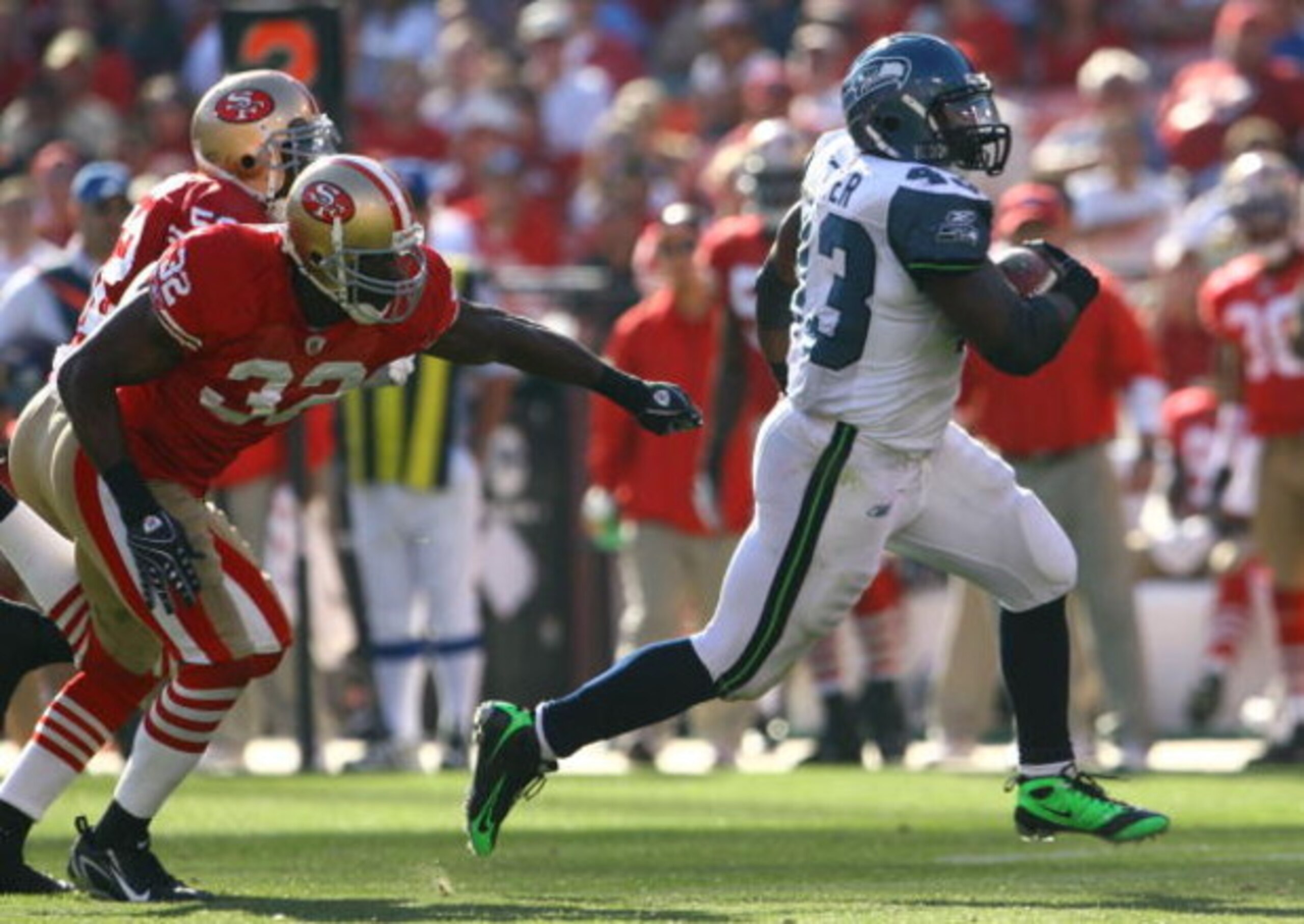 SAN FRANCISCO - OCTOBER 26:  Fullback Leonard Weaver #43 of the Seattle Seahawks outruns Michael Lewis #32 of the San Francisco 49ers for a touchdown in the third quarter at Candlestick Park on October 26, 2008 in San Francisco, California. The Seahawks d