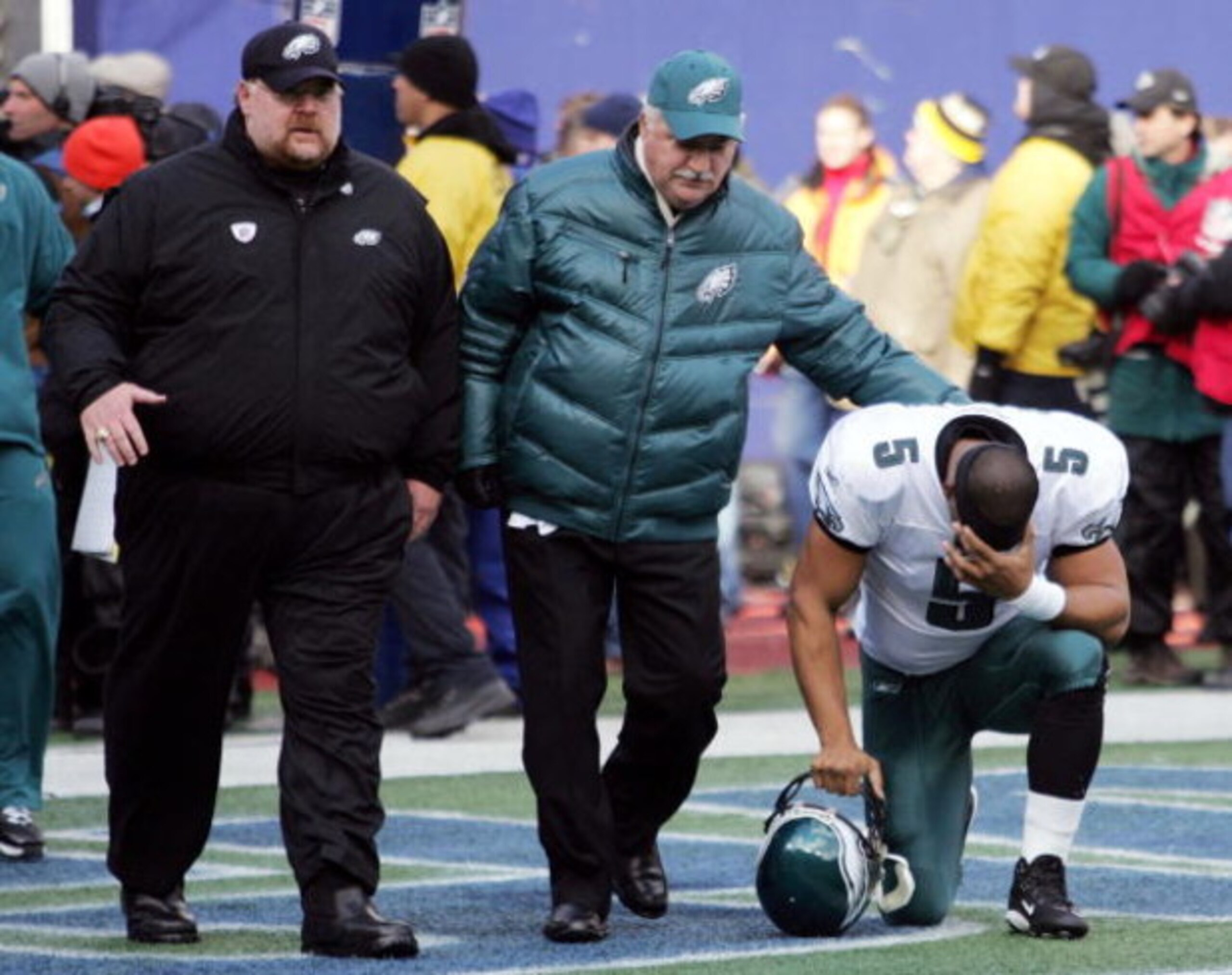EAST RUTHERFORD, NJ - JANUARY 11:  Quarterback Donovan McNabb #5 of the Philadelphia Eagles kneels after in the end zone as Head Coach Andy Reid walks by after their NFC Divisional Playoff Game against the New York Giants on January 11, 2009 at Giants Sta