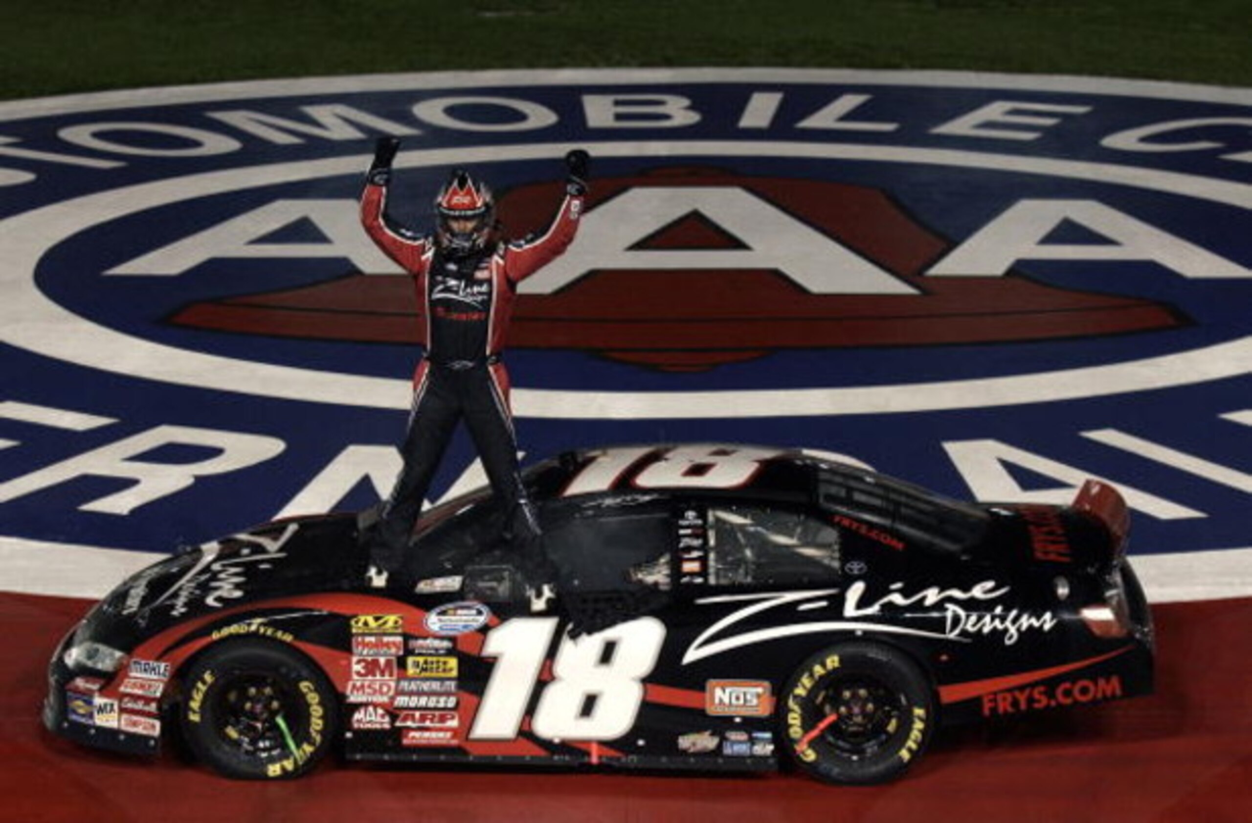 FONTANA, CA - FEBRUARY 21:  Kyle Busch, driver of the #18 Z-Line Designs Toyota, celebrates winning the NASCAR Nationwide Series Stater Bros. 300 at Auto Club Speedway on February 21, 2009 in Fontana, California.  (Photo by Jason Smith/Getty Images for NA