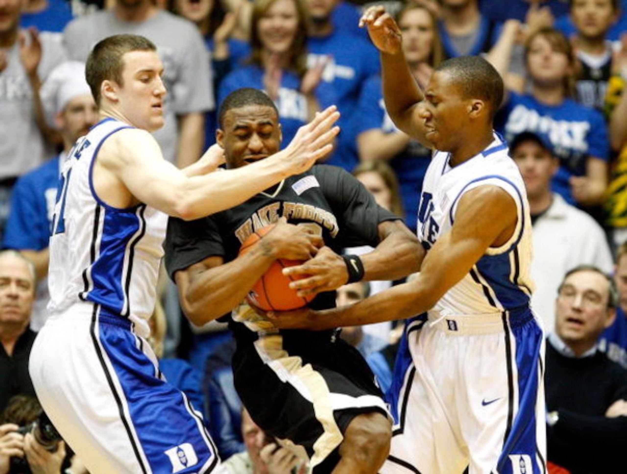 DURHAM, NC - FEBRUARY 22:  L.D. Williams #42 of the Wake Forest Demon Deacons is trapped by teammates Miles Plumlee #21 and Nolan Smith #2 of the Duke Blue Devils during their game at Cameron Indoor Stadium on February 22, 2009 in Durham, North Carolina. 