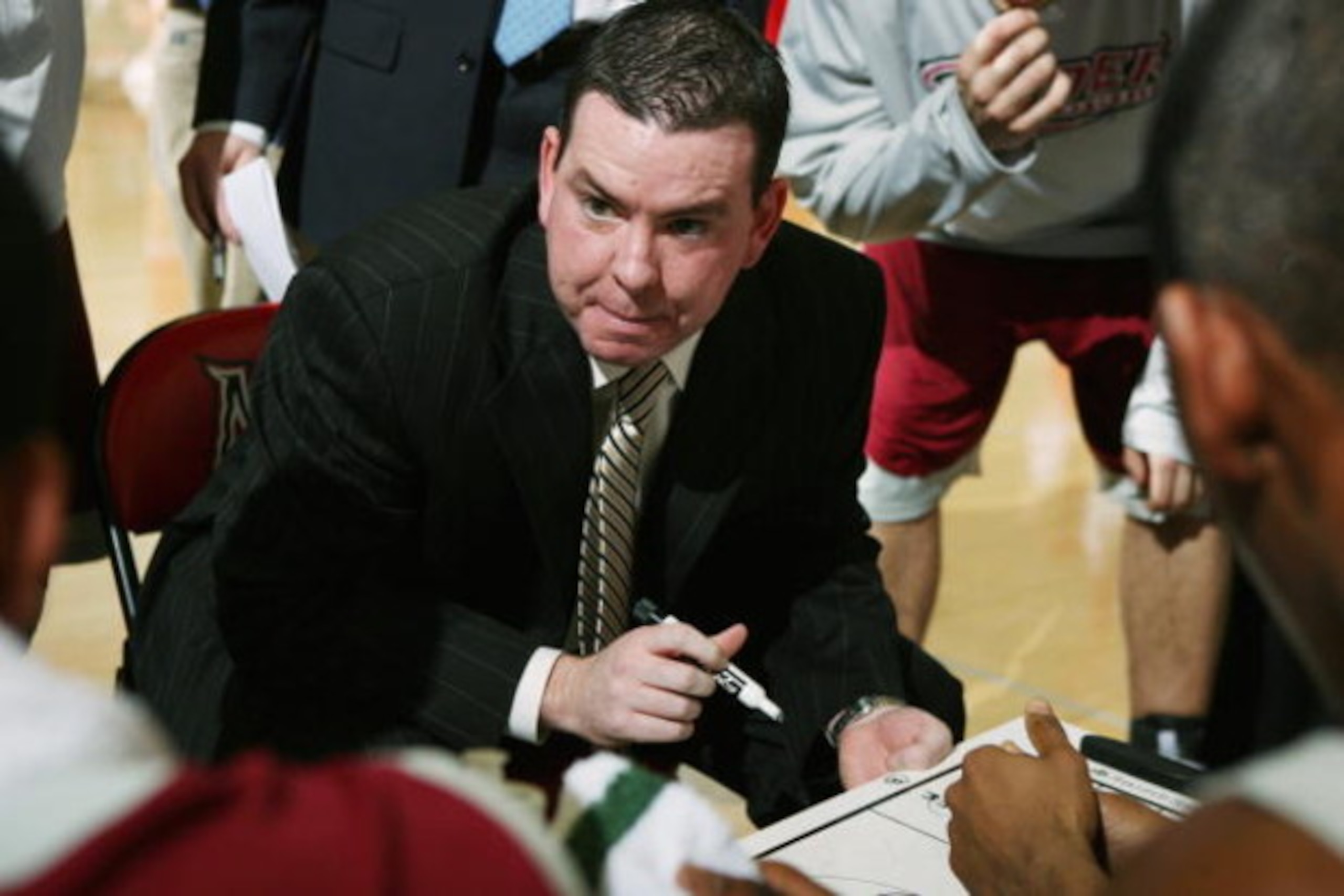 NORTHRIDGE, CA - FEBRUARY 23:  Head coach Tommy Dempsey of the Rider Broncos talks to his team during a timout in the game against the Cal State Northridge Matadors on February 23, 2008 at the Matadome in Northridge, California.  Rider won 73-72.  (Photo 