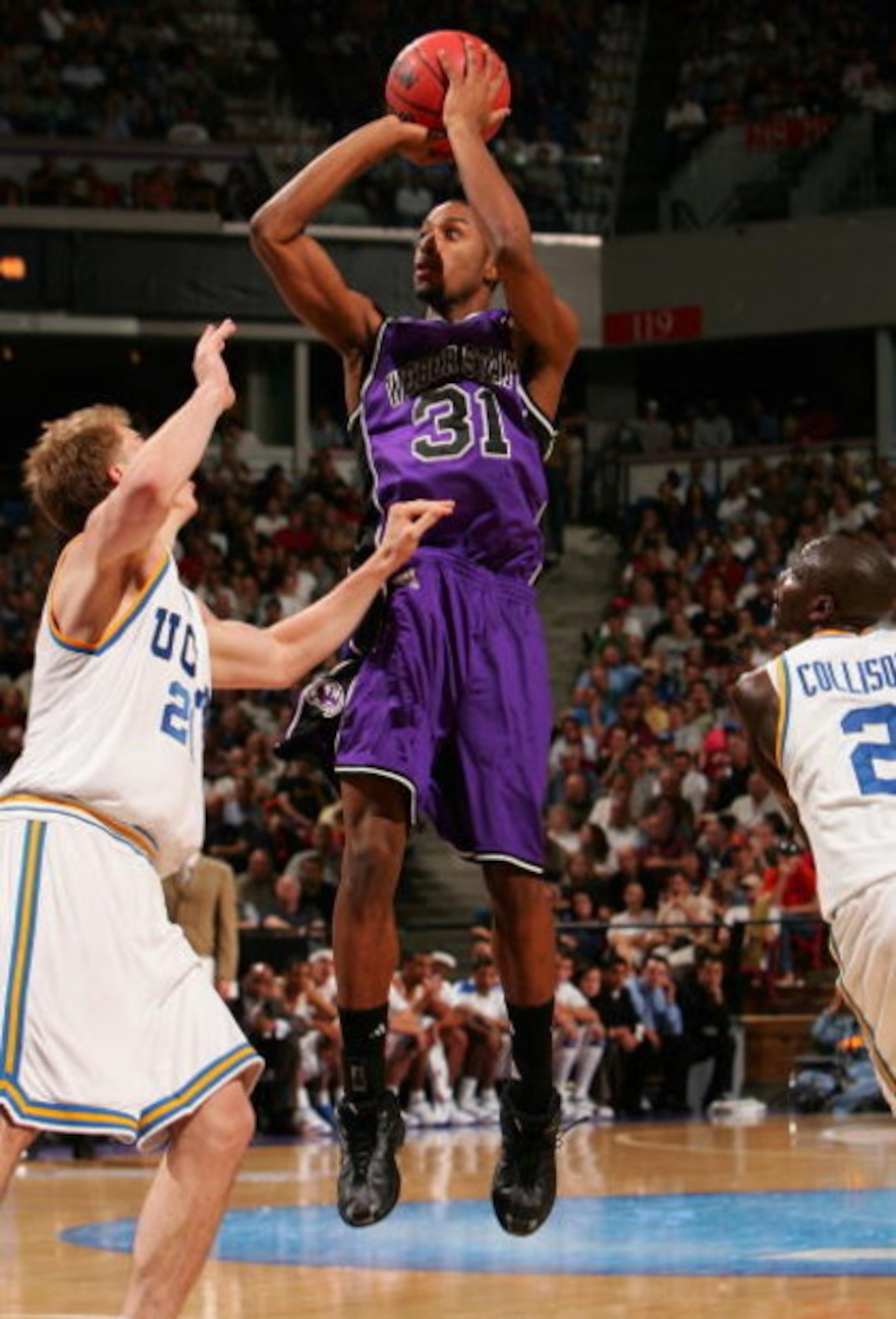 SACRAMENTO, CA - MARCH 15:  Daviin Davis #31 of the Weber State Wildcats puts up a shot over Michael Roll #20 of the UCLA Bruins during round one of the NCAA Men's Basketball Tournament at Arco Arena on March 15, 2007 in Sacramento, California.    (Photo 