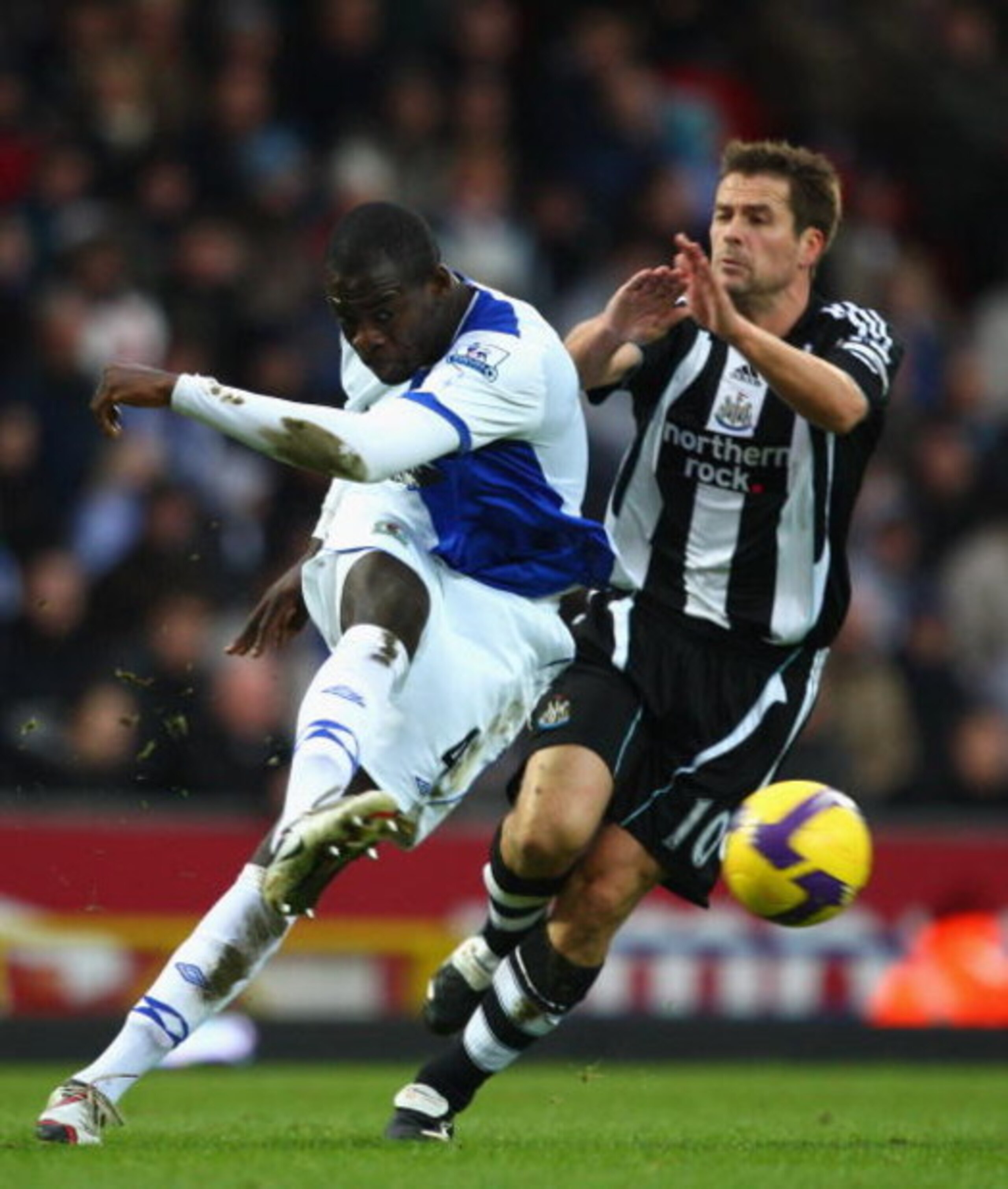 BLACKBURN, UNITED KINGDOM - JANUARY 17: Christopher Samba of Blackburn clears from Michael Owen of Newcastle during the Barclays Premier League match between Blackburn Rovers and Newcastle United at Ewood Park on January 17, 2009 in Blackburn, England. ( BLACKBURN, UNITED KINGDOM - JANUARY 17: Christopher Samba of Blackburn clears from Michael Owen of Newcastle during the Barclays Premier League match between Blackburn Rovers and Newcastle United at Ewood Park on January 17, 2009 in Blackburn, England. (