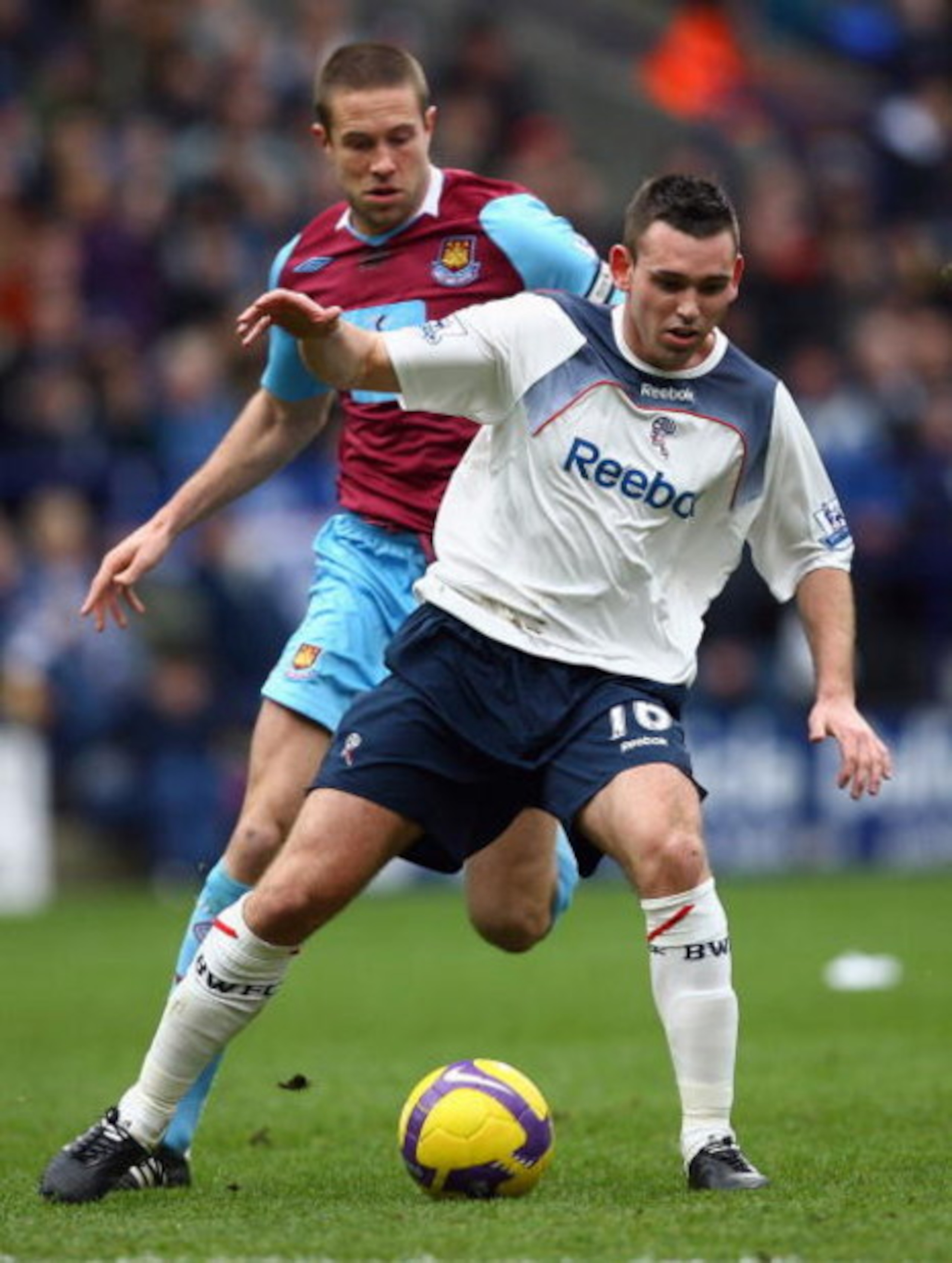 BOLTON, UNITED KINGDOM - FEBRUARY 21: Mark Davies of Bolton Wanderers holds off a challenge from Matthew Upson of West Ham United during the Barclays Premier League match between Bolton Wanderers and West Ham United at the Reebok Stadium on February 21, BOLTON, UNITED KINGDOM - FEBRUARY 21: Mark Davies of Bolton Wanderers holds off a challenge from Matthew Upson of West Ham United during the Barclays Premier League match between Bolton Wanderers and West Ham United at the Reebok Stadium on February 21,