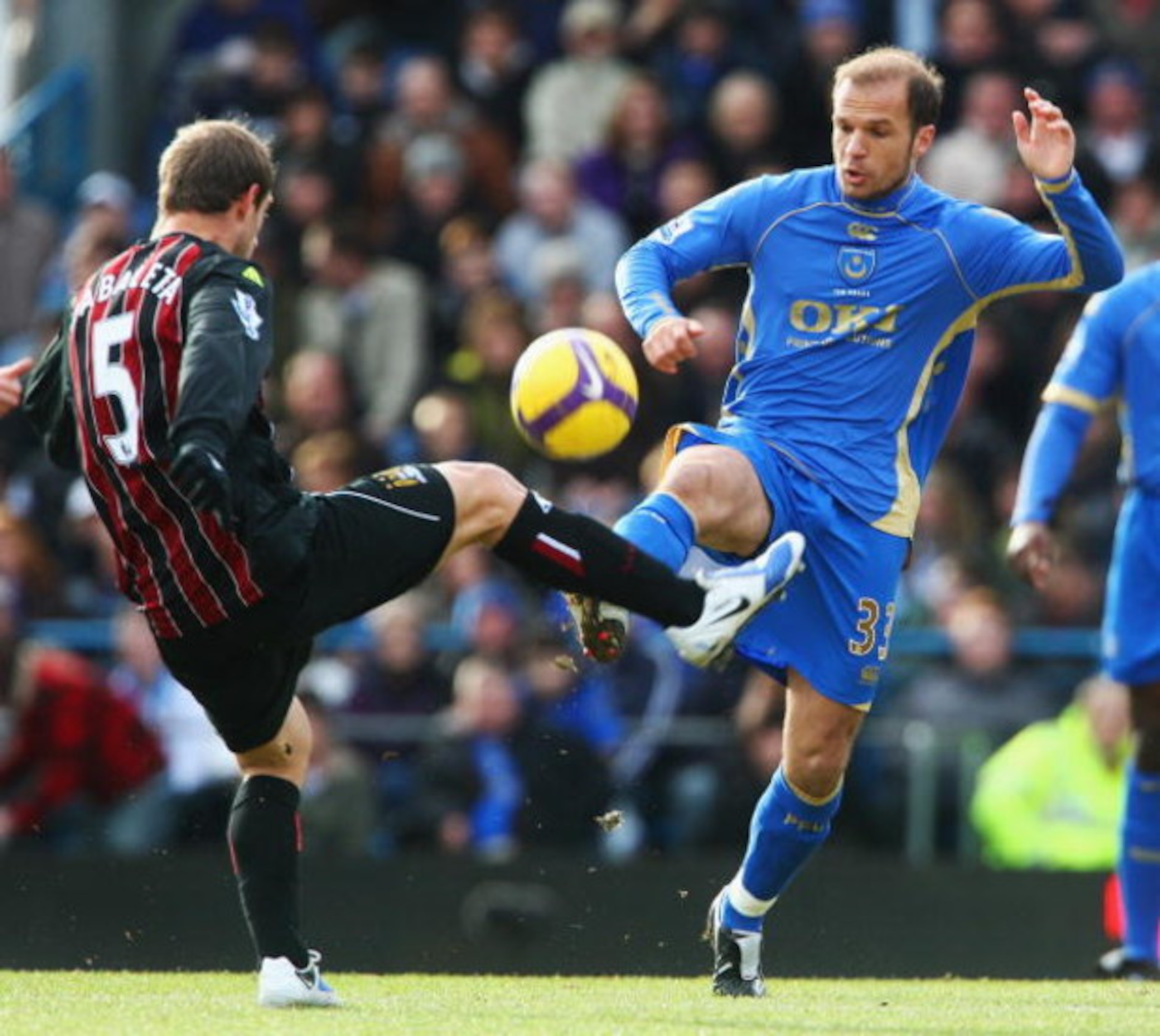 PORTSMOUTH, UNITED KINGDOM - FEBRUARY 14: Angelos Basinas (R) of Portsmouth competes for the ball with Pablo Zabaleta (L) of Manchester City during the Barclays Premier League match between Portsmouth and Manchester City at Fratton Park on February 14, 2 PORTSMOUTH, UNITED KINGDOM - FEBRUARY 14: Angelos Basinas (R) of Portsmouth competes for the ball with Pablo Zabaleta (L) of Manchester City during the Barclays Premier League match between Portsmouth and Manchester City at Fratton Park on February 14, 2