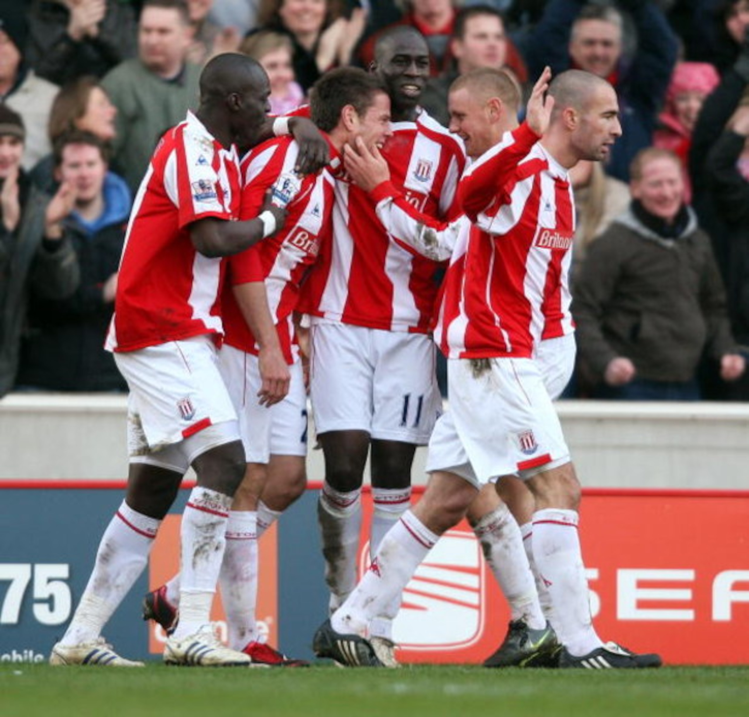 STOKE, UNITED KINGDOM - FEBRUARY 21: Kevin Beattie of Stoke is congratulated after scores from the penalty spot during the Barclays Premiership match between Stoke City and Portsmouth at The Britanina Stadium on February 21, 2009 in Stoke,England. (Phot STOKE, UNITED KINGDOM - FEBRUARY 21: Kevin Beattie of Stoke is congratulated after scores from the penalty spot during the Barclays Premiership match between Stoke City and Portsmouth at The Britanina Stadium on February 21, 2009 in Stoke,England. (Phot