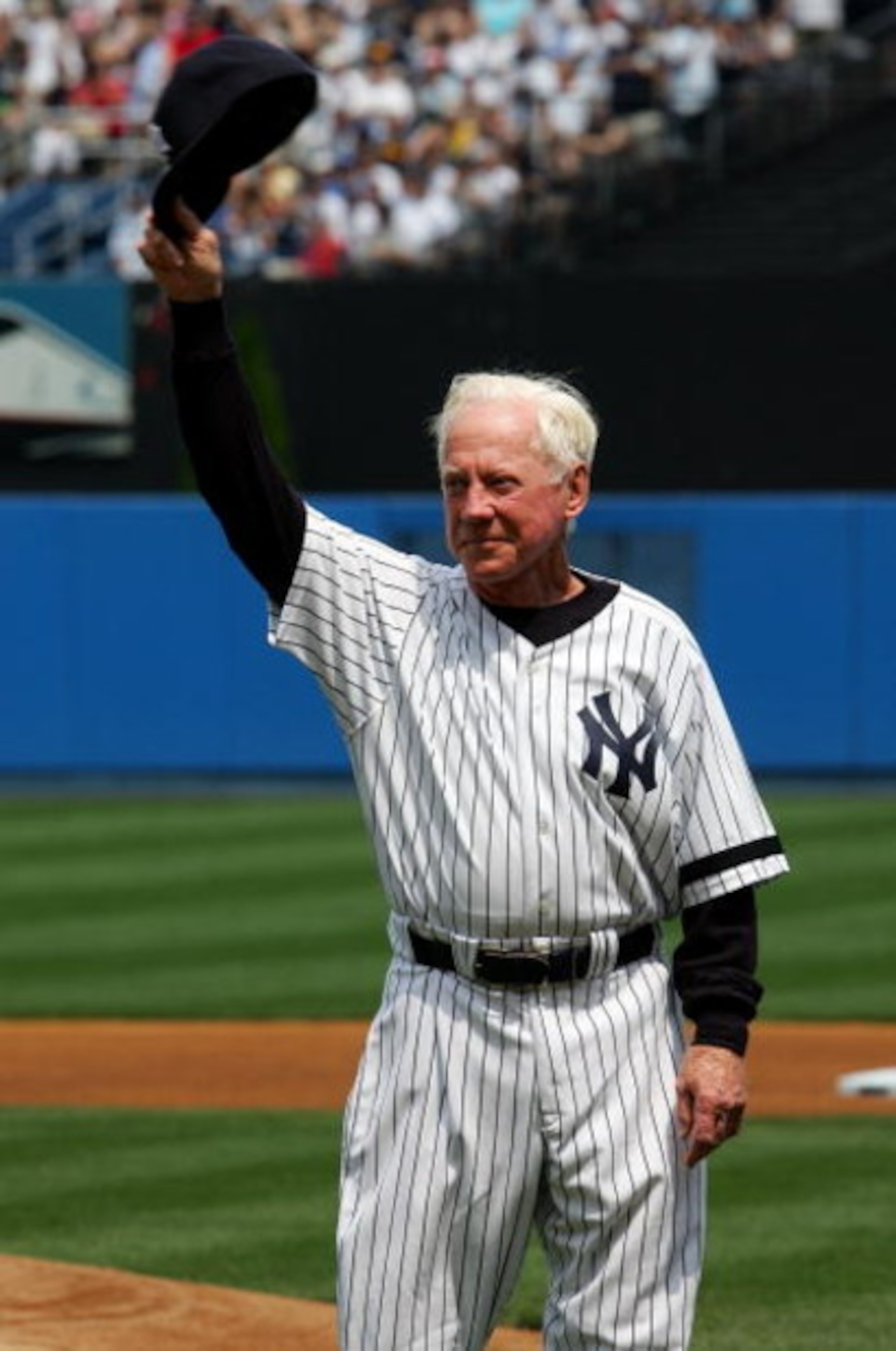 NEW YORK - JULY 07:  Former New York Yankee Whitey Ford salutes the crowd during Old Timers Day ceremonies before the Yankees play the Los Angeles Angels of Anaheim at Yankee Stadium on July 7, 2007 in the Bronx borough of New York City.  (Photo by Jim Mc