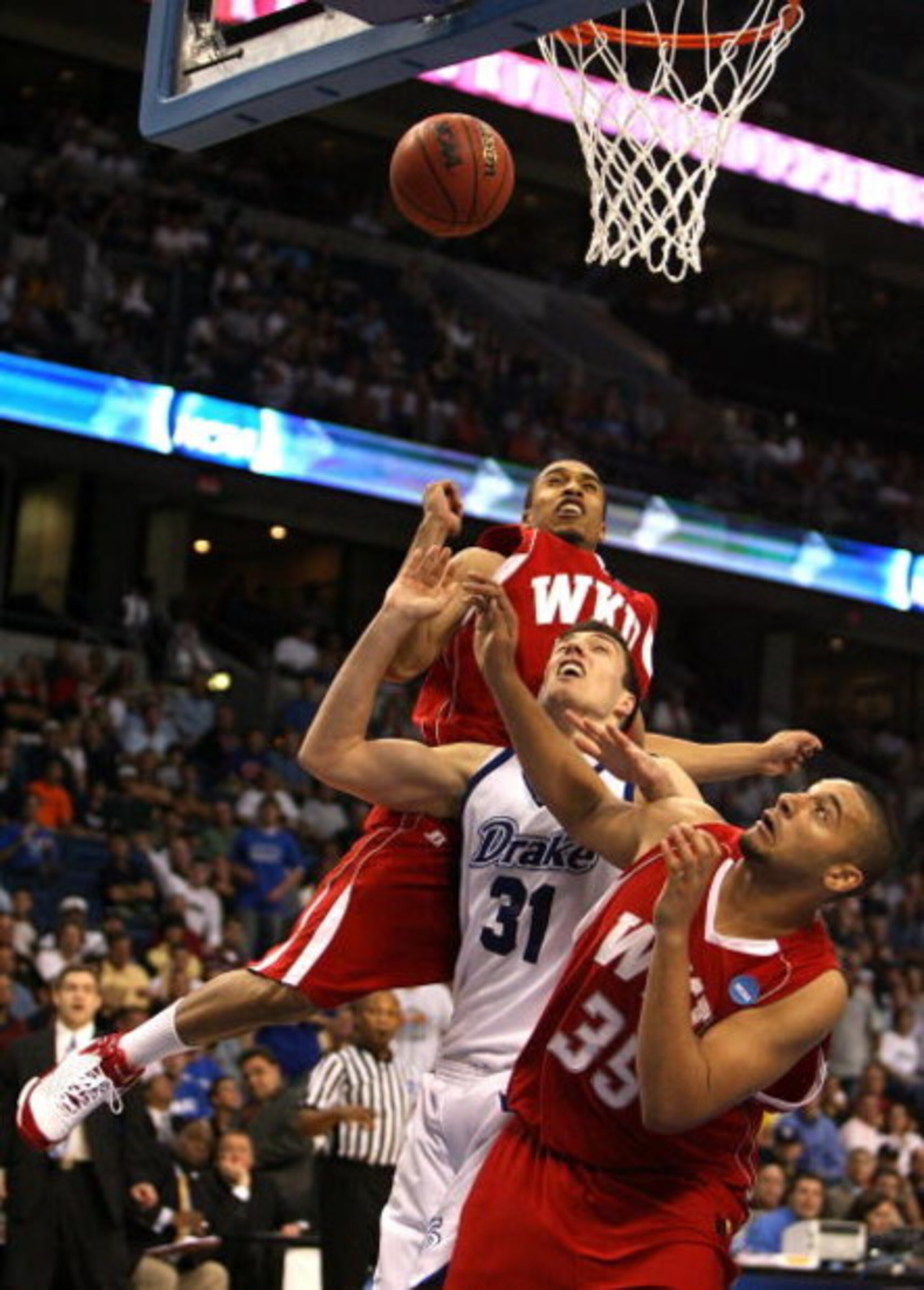 TAMPA, FL - MARCH 21:  Jonathan Cox #31 of the Drake Bulldogs fights for a rebound with D.J. Magley #35 and Courtney Lee #32 of the Western Kentucky Hilltoppers during the first round of the 2008 NCAA Tournament West Regional at the St. Pete Times Forum o