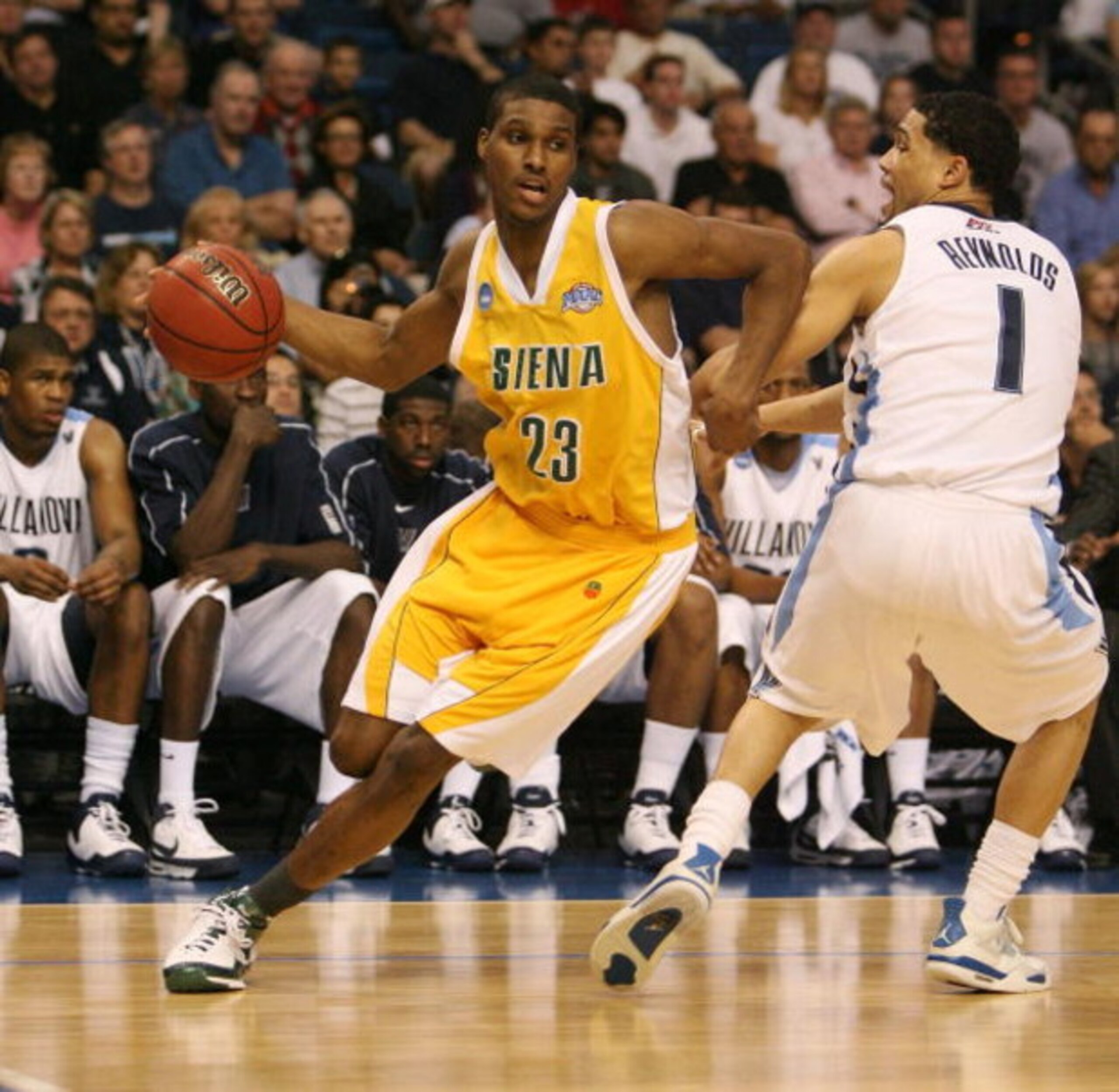 TAMPA, FL - MARCH 23:  Edwin Ubiles #23 of the Siena Saints brings the ball toward the basket agianst Scottie Reynolds #1 of the Villanova Wildcats in the second round of the 2008 NCAA Tournament Midwest Regional at the St. Pete Times Forum on March 23, 2