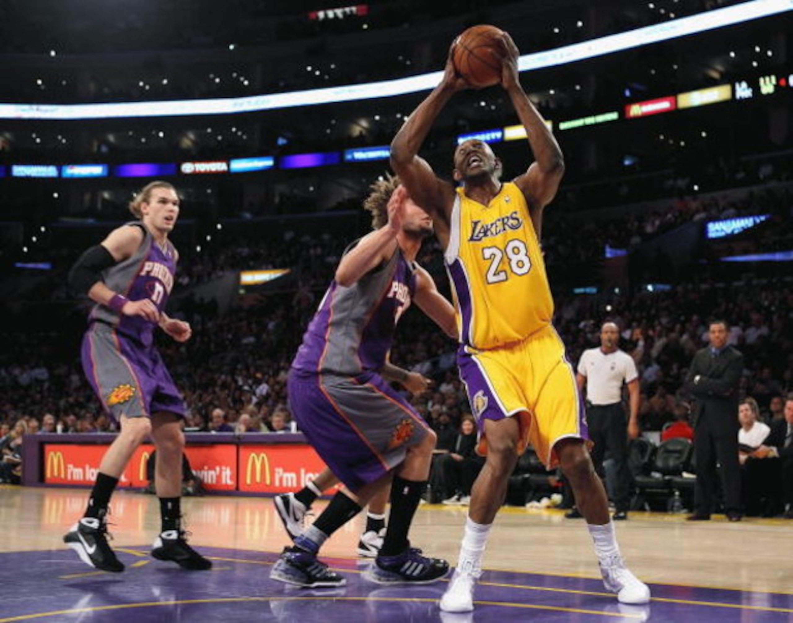 LOS ANGELES, CA - FEBRUARY 26: Didier Ilunga-Mbenga #28 of the Los Angeles Lakers goes to the basket over Robin Lopez #15 of the Phoeix Suns during the NBA game at Staples Center on February 26, 2009 in Los Angeles, California. The Lakers defeated the S LOS ANGELES, CA - FEBRUARY 26: Didier Ilunga-Mbenga #28 of the Los Angeles Lakers goes to the basket over Robin Lopez #15 of the Phoeix Suns during the NBA game at Staples Center on February 26, 2009 in Los Angeles, California. The Lakers defeated the S
