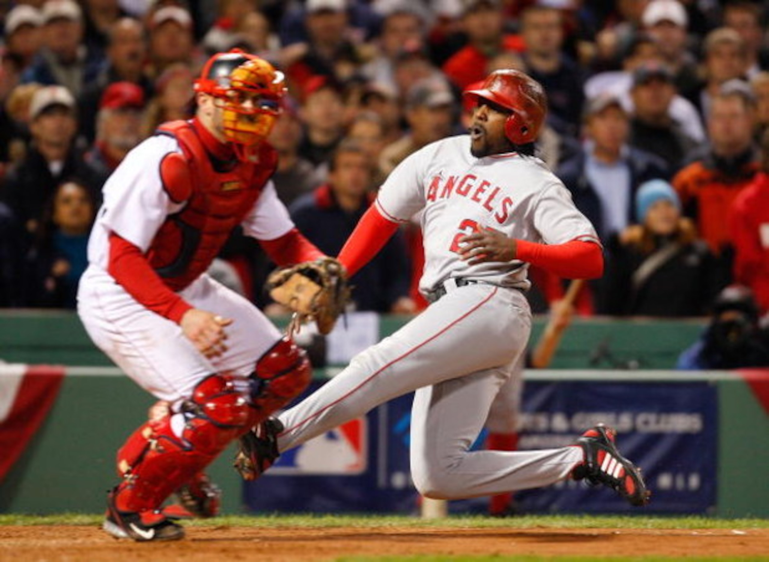 BOSTON - OCTOBER 6: Vladimir Guerrero #27 of the Los Angeles Angels of Anaheim scores the tying run in the 8th inning against the Boston Red Sox during game four of the American League Division Series at Fenway Park on October 6, 2008 in Boston, Massachus