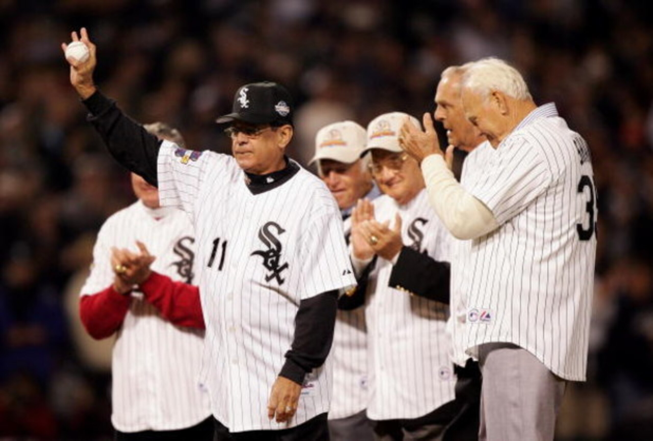 CHICAGO - OCTOBER 22:  Baseball Hall of Famer and former Chicago White Sox player Luis Aparicio waves from the mound with other former White Sox players before the ceremonial first pitch before the Chicago White Sox take on the Houston Astros during Game 