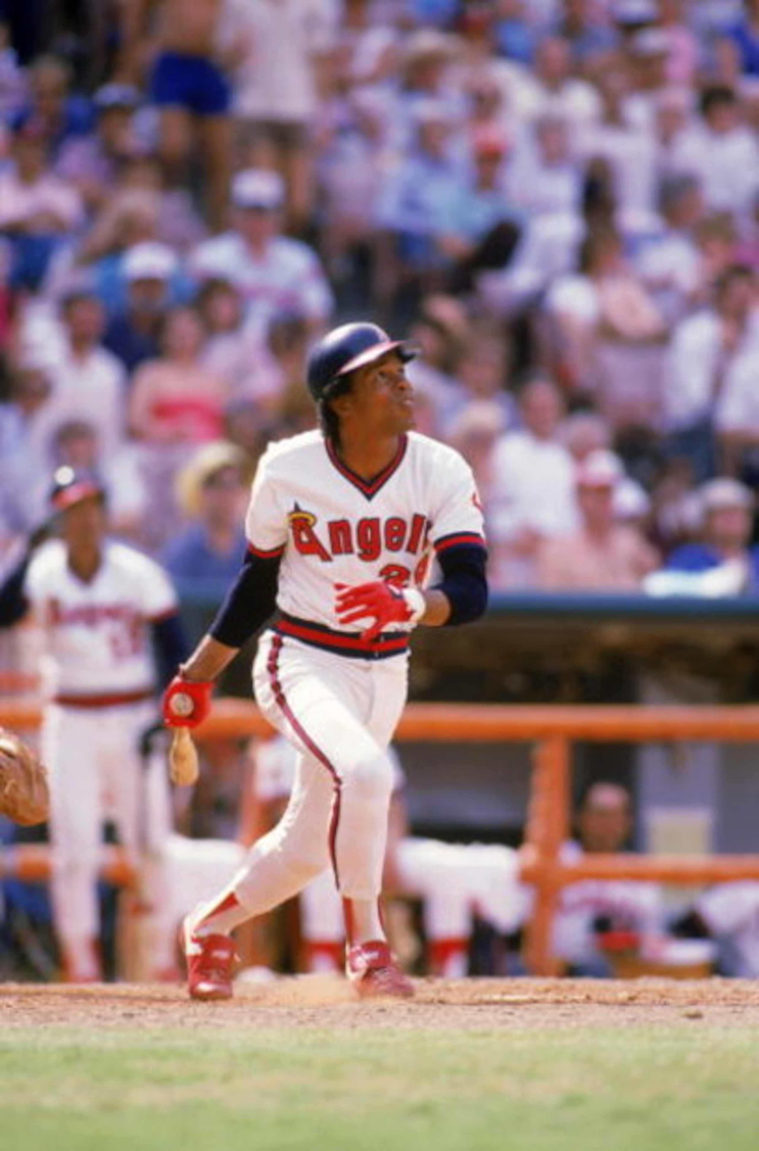 ANAHEIM, CA - 1985:  Infielder Rod Carew #29 of the California Angels watches the flight of his hit as he runs to first during a 1985 MLB game at Angel Stadium in Anaheim, California. (Photo by Rick Stewart/Getty Images)