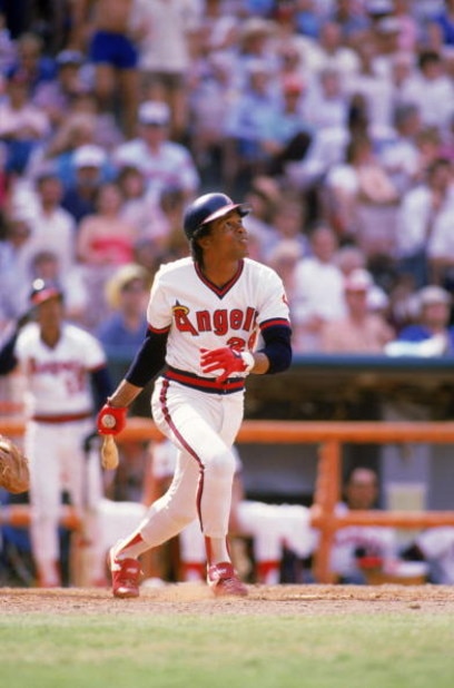 ANAHEIM, CA - 1985:  Infielder Rod Carew #29 of the California Angels watches the flight of his hit as he runs to first during a 1985 MLB game at Angel Stadium in Anaheim, California. (Photo by Rick Stewart/Getty Images)