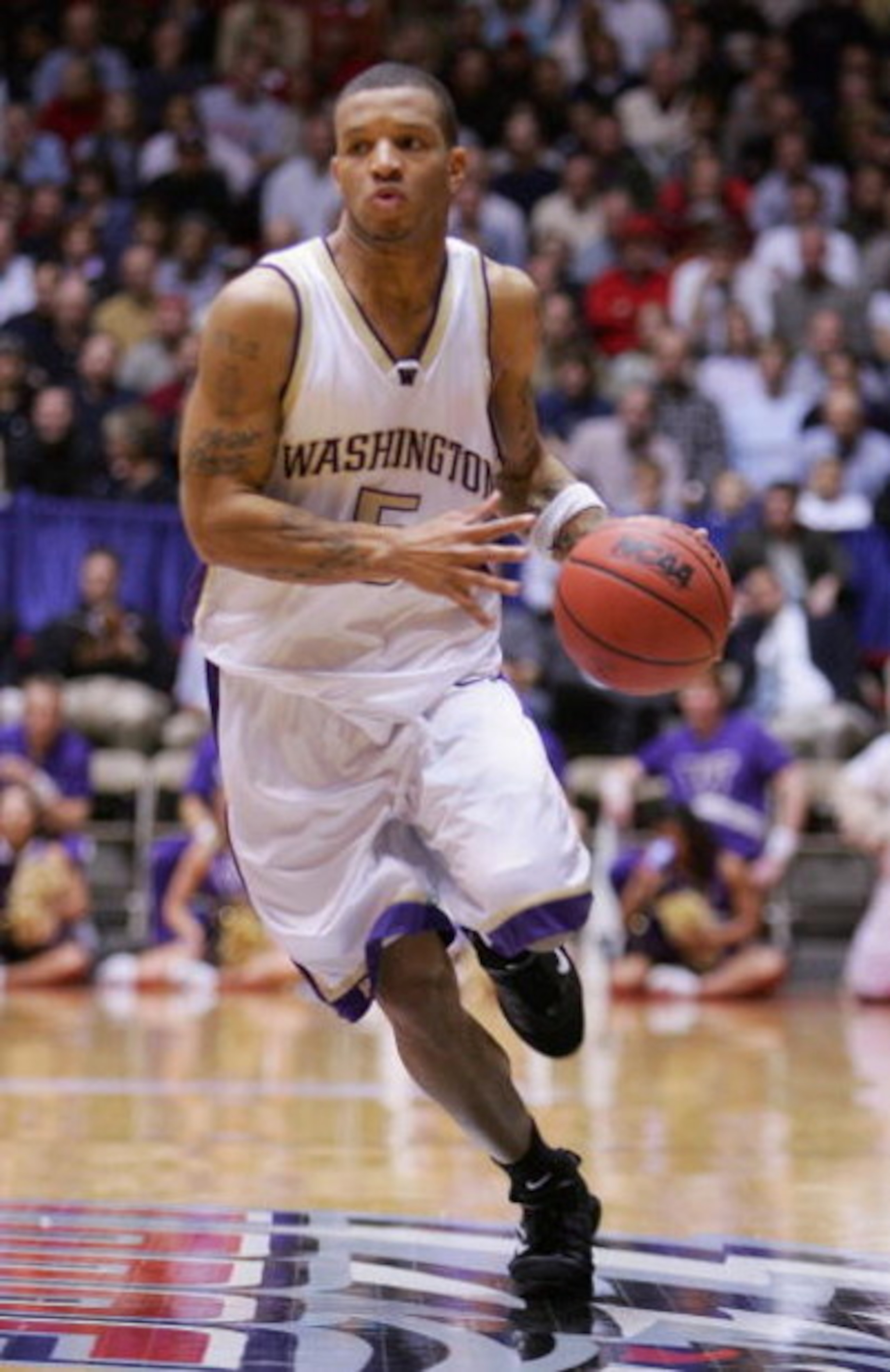 ALBUQUERQUE, NM - MARCH 24:  Will Conroy #5 of the Washington Huskies moves the ball in the game against the Louisville Cardinals during the Sweet 16 game of the NCAA Division I Men's Basketball Tournament on March 24, 2005 at The Pit in Albuquerque, New 