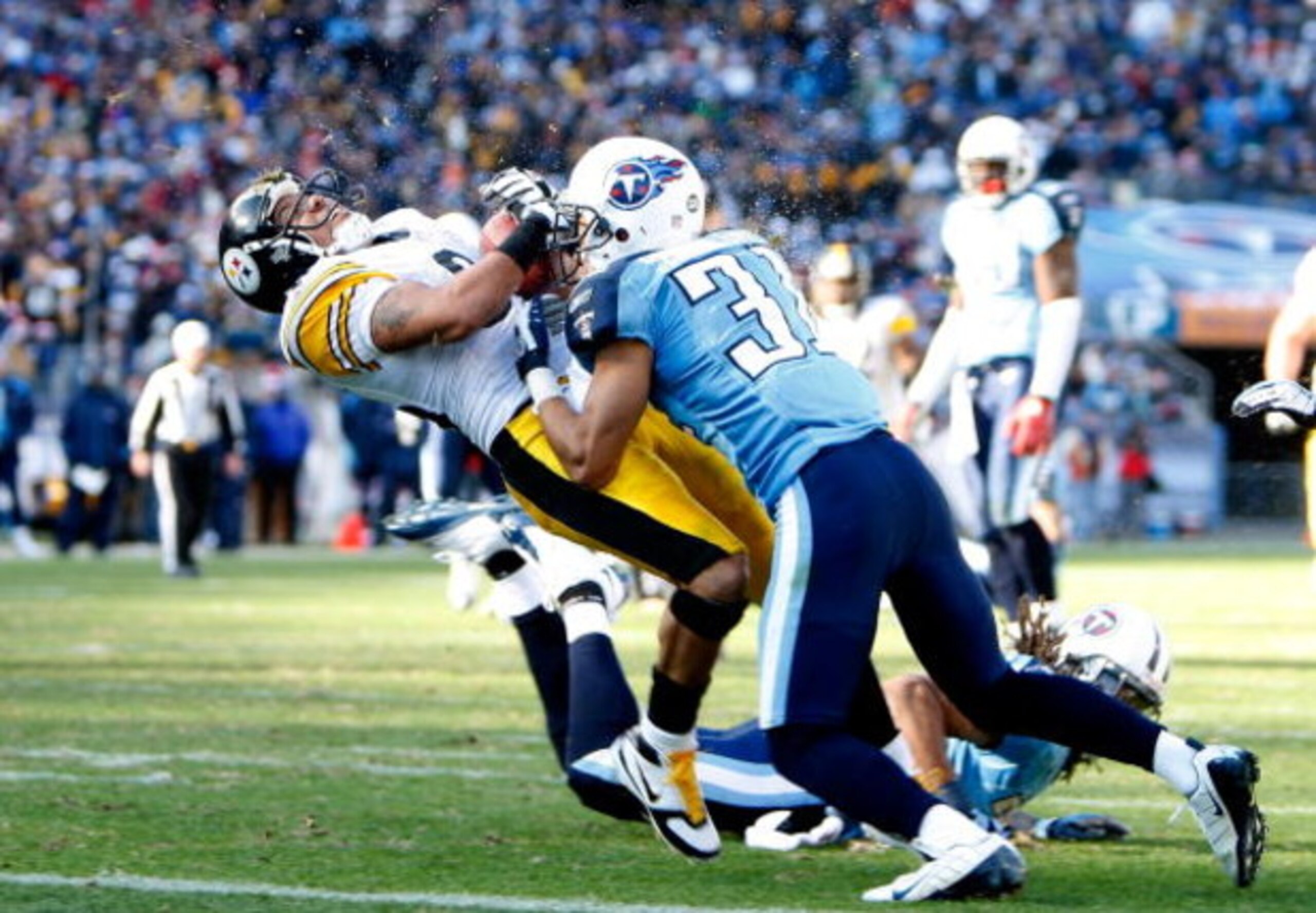 NASHVILLE, TN - DECEMBER 21:  Hines Ward #86 of the Pittsburgh Steelers is hit hard by Cortland Finnegan #31 of the Tennessee Titans as he scores a touchdown during their game on December 21, 2008 at LP Field in Nashville, Tennessee.  (Photo by Streeter L