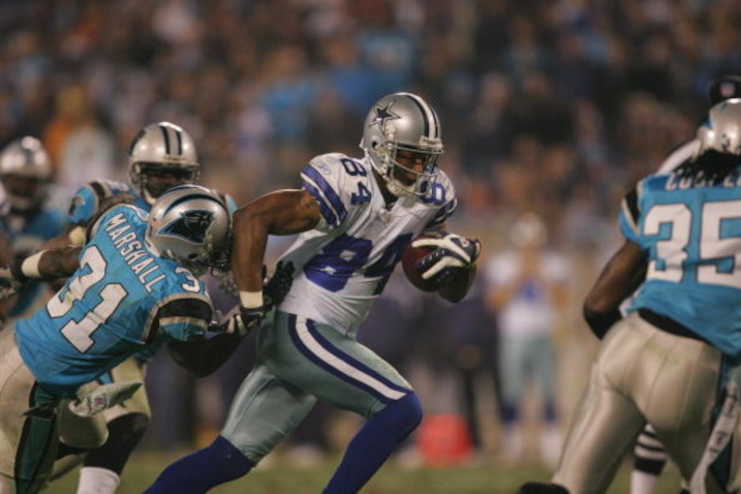 CHARLOTTE, NC - DECEMBER 22:  Patrick Crayton #84 of the Dallas Cowboys tries to break a tackle against the Carolina Panthers during their game at Bank of America Stadium on December 22, 2007 in Charlotte, North Carolina. (Photo by Streeter Lecka/Getty Im