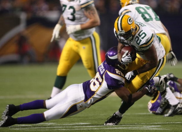 MINNEAPOLIS - NOVEMBER 09:  Running back Ryan Grant #25 of the Green Bay Packers carries the ball against cornerback Antoine Winfield #26 of the Minnesota Vikings on November 9, 2008 at the Metrodome in Mineapolis, Minnesota.  The Vikings won 28-27.  (Pho