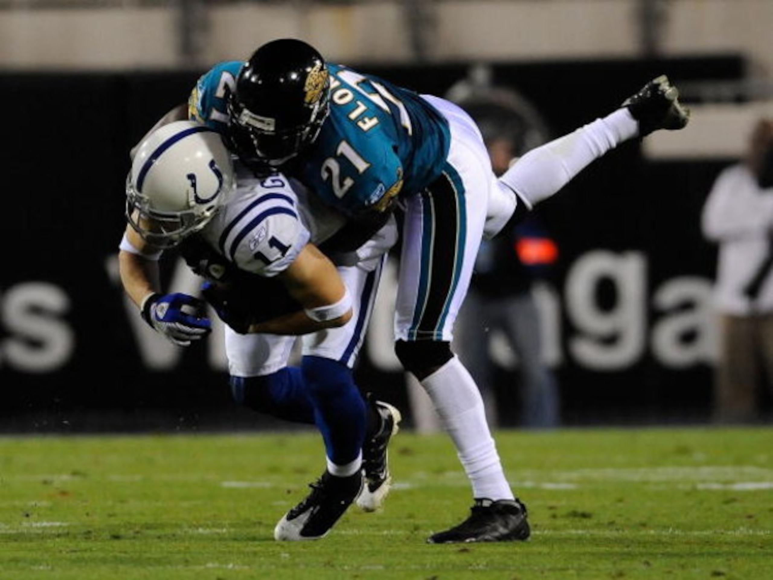 JACKSONVILLE, FL - DECEMBER 18:  Anthony Gonzalez #11 of the Indianapolis Colts is tackled by Drayton Florence #21 of the Jacksonville Jaguars during the game at Jacksonville Municipal Stadium on December 18, 2008 in Jacksonville, Florida.  (Photo by Sam 
