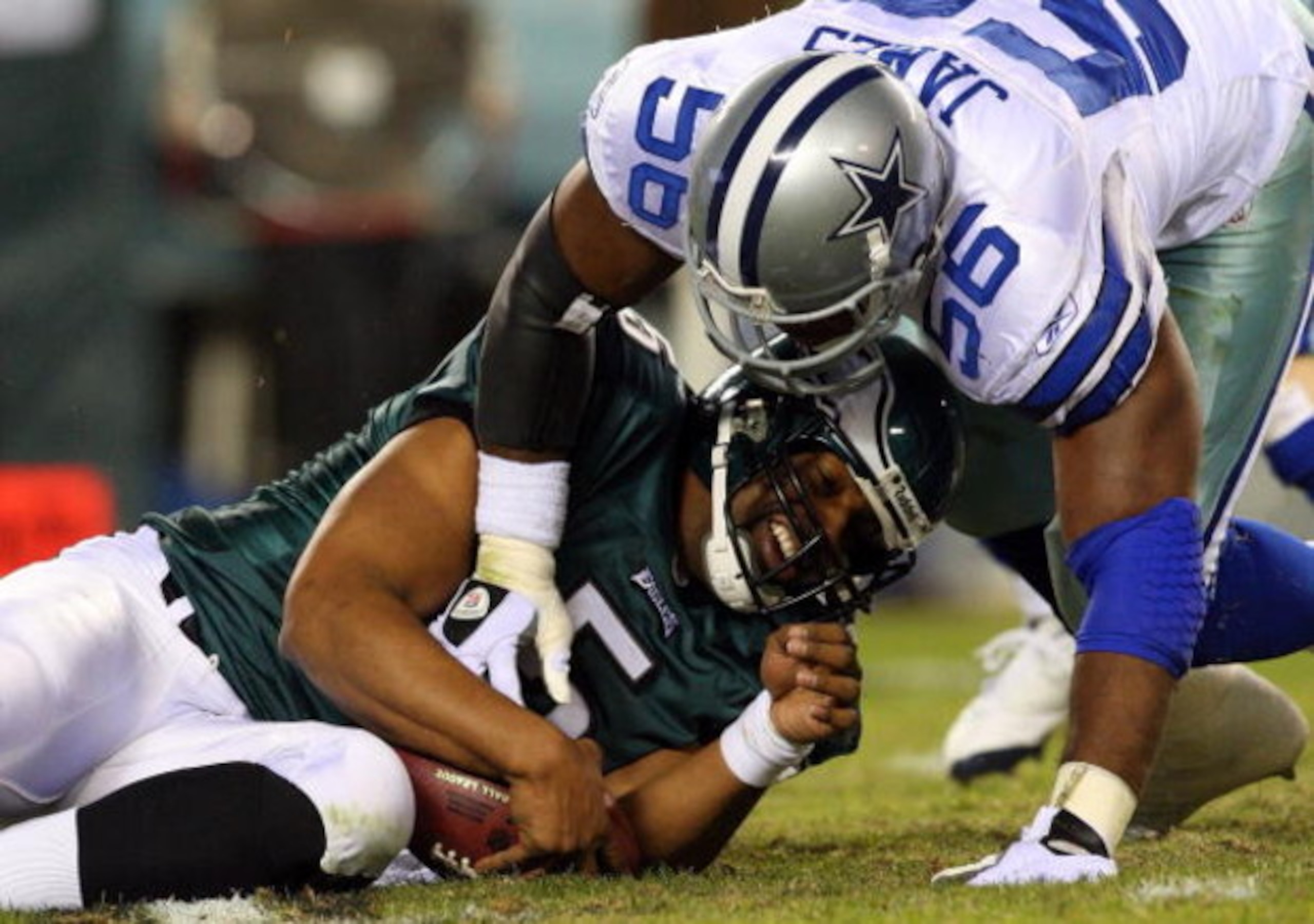 PHILADELPHIA - DECEMBER 28:  Bradie James #56 of the Dallas Cowboys sacks Donovan McNabb #5 of the Philadelphia Eagles on December 28, 2008 at Lincoln Financial Field in Philadelphia, Pennsylvania.  (Photo by Jim McIsaac/Getty Images)