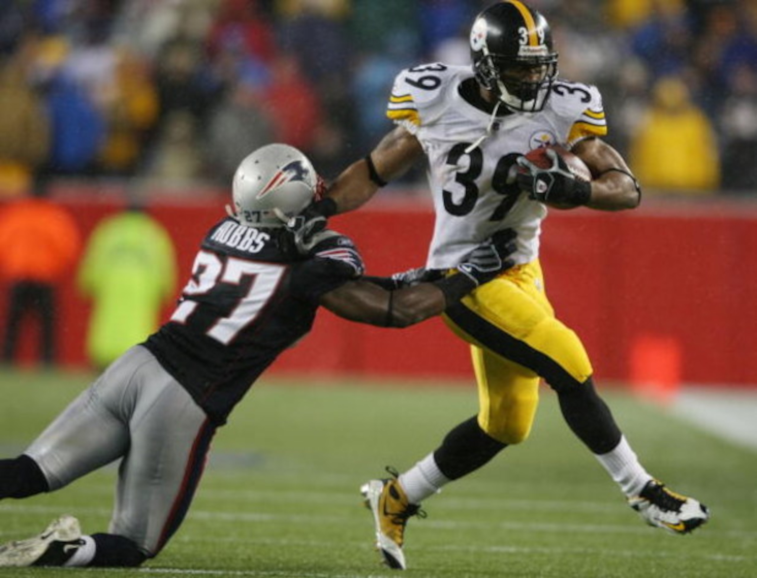 FOXBORO, MA - NOVEMBER 30:  Ellis Hobbs III #27 of the New England Patriots tries to pull down Willie Parker #39 of the Pittsburgh Steelers on November 30, 2008 at Gillette Stadium in Foxboro, Massachusetts.  The Steelers defeated the Patriots 33-10. (Pho