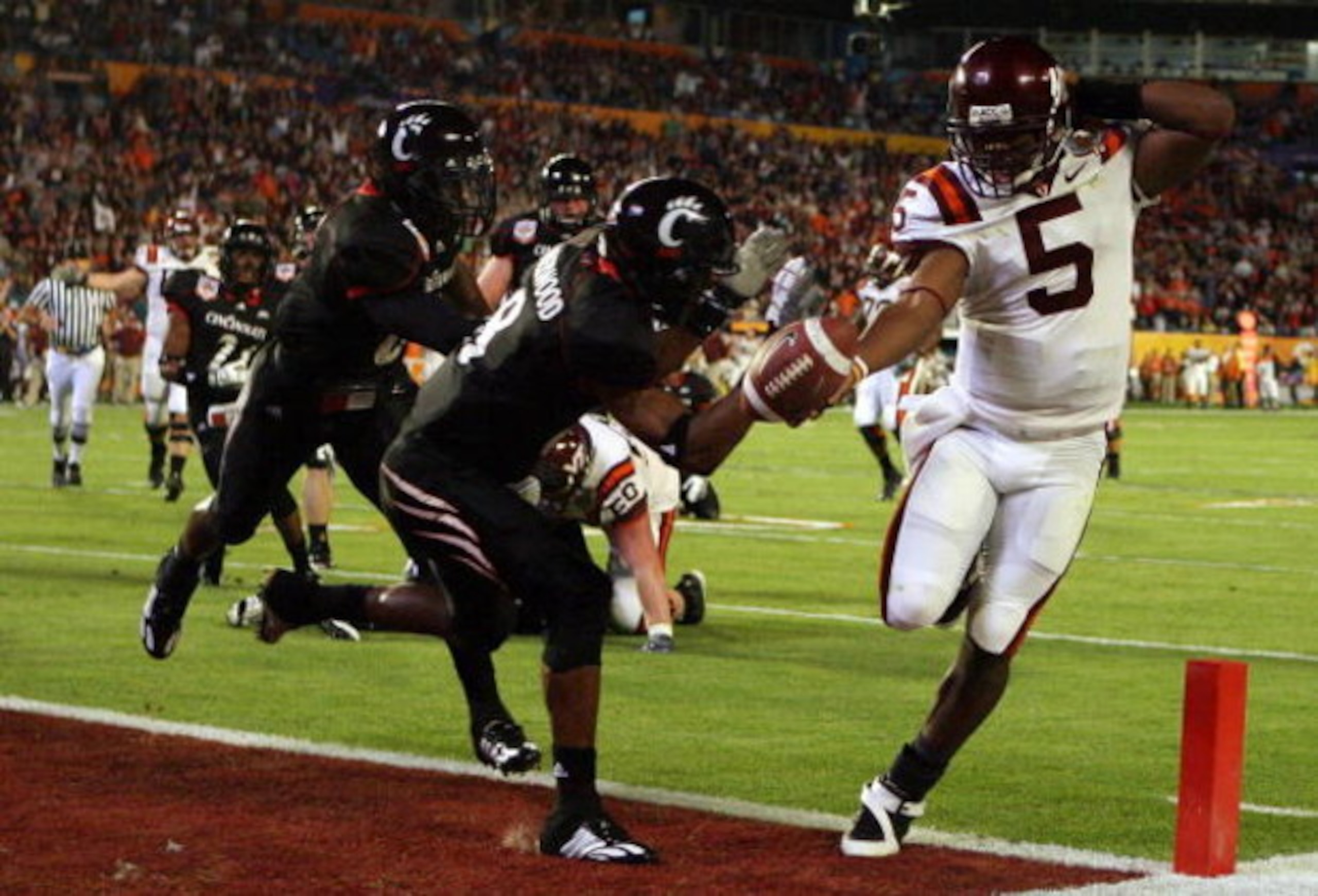 MIAMI - JANUARY 01:  Tyrod Taylor #5 of the Virginia Tech Hokies runs the ball for a toucdown against Brandon Underwood #8 of the Cincinnati Bearcats during the FedEx Orange Bowl against at Dolphin Stadium on January 1, 2009 in Miami, Florida.  (Photo by 