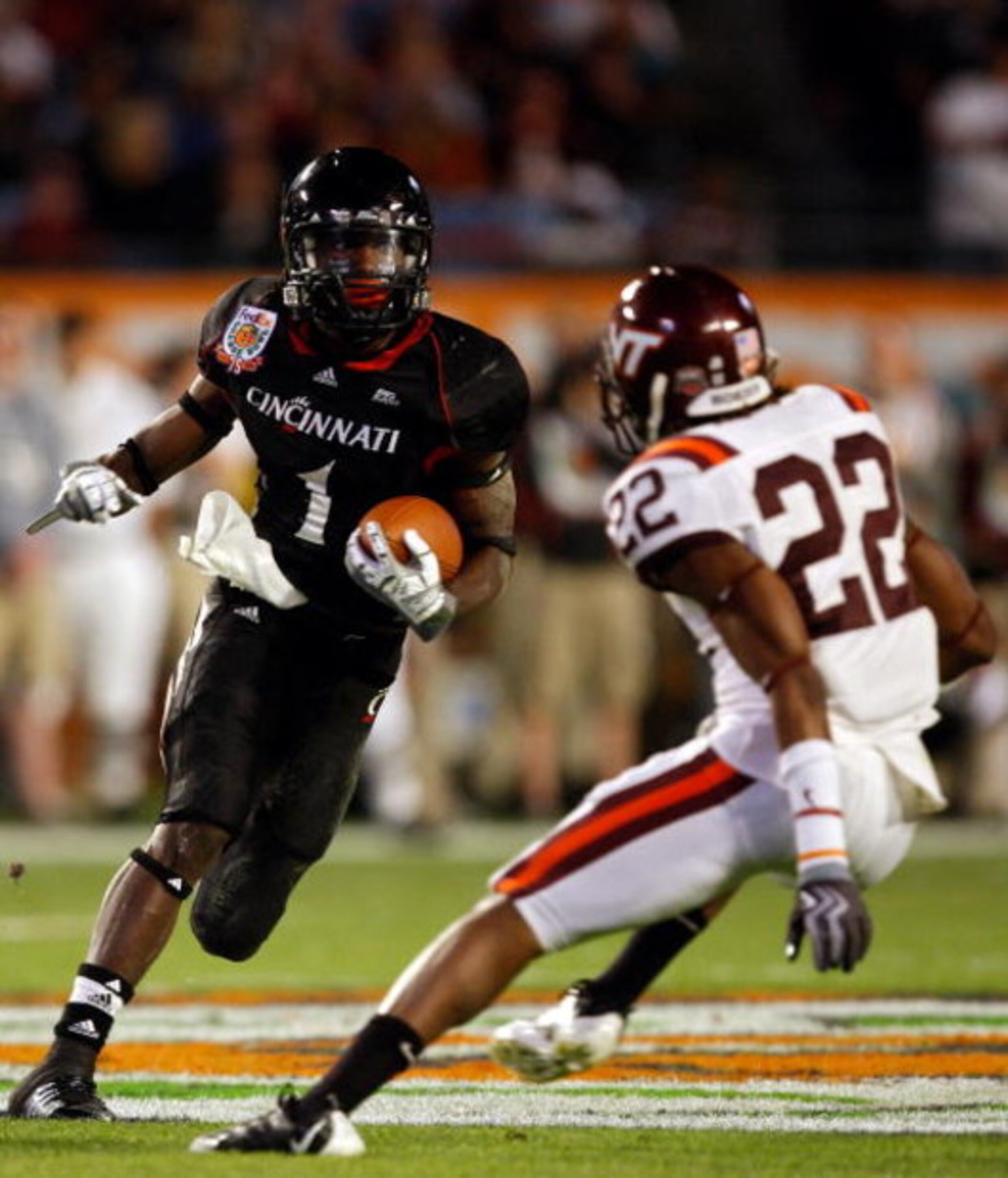 MIAMI - JANUARY 01:  Josh Oglesby #1 of the Cincinnati Bearcats runs with the ball against Stephan Virgil #22 of the Virginia Tech Hokies during the FedEx Orange Bowl at Dolphin Stadium on January 1, 2009 in Miami, Florida.  (Photo by Streeter Lecka/Getty