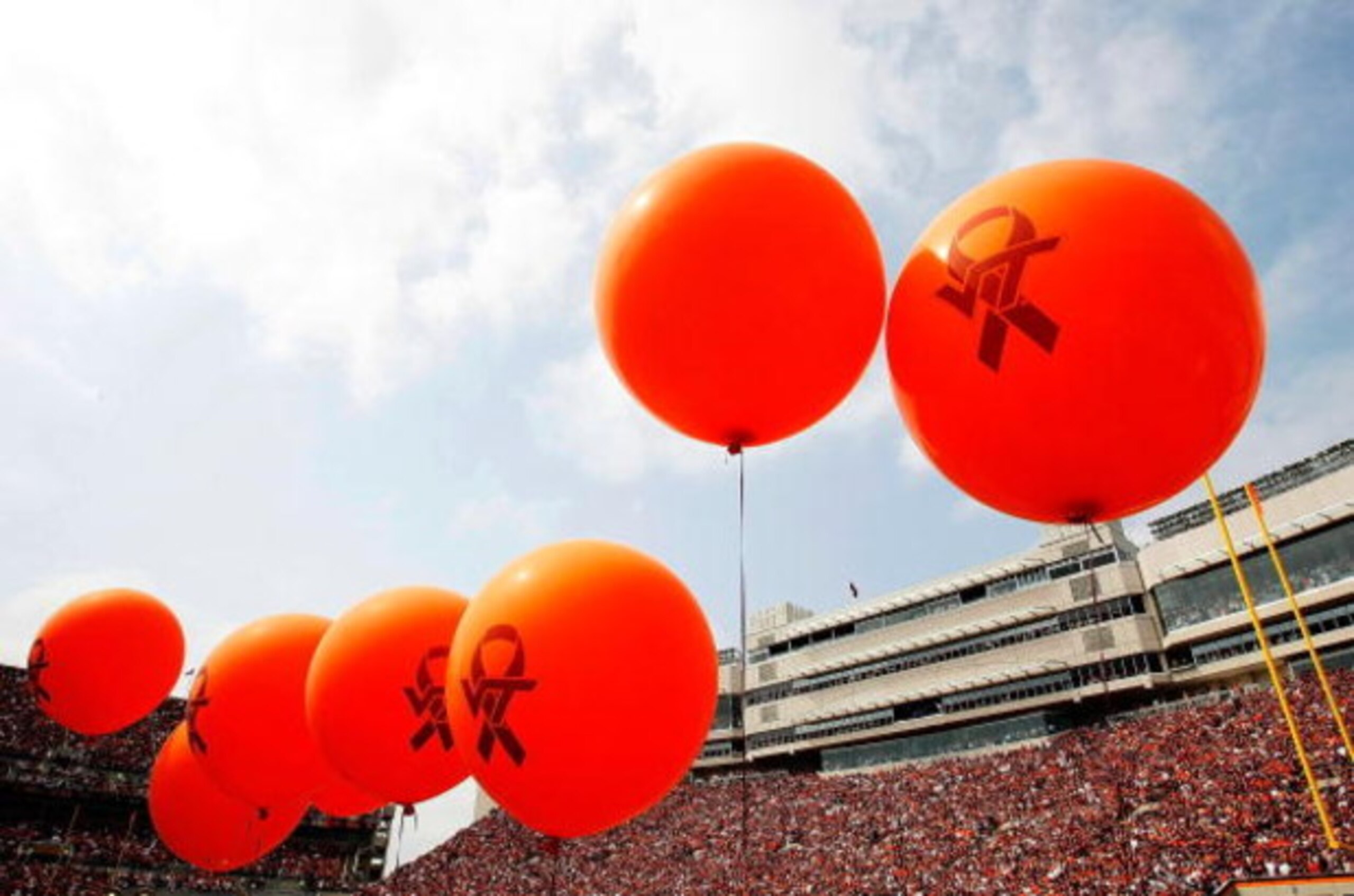 BLACKSBURG, VA - SEPTEMBER 01:  Members of the Virginia Tech cheerleading squad and pep squad hold balloons representing the 32 victims of the shooting at the school, before the start of the season opener September 1, 2007 at Lane Stadium in Blacksburg, V