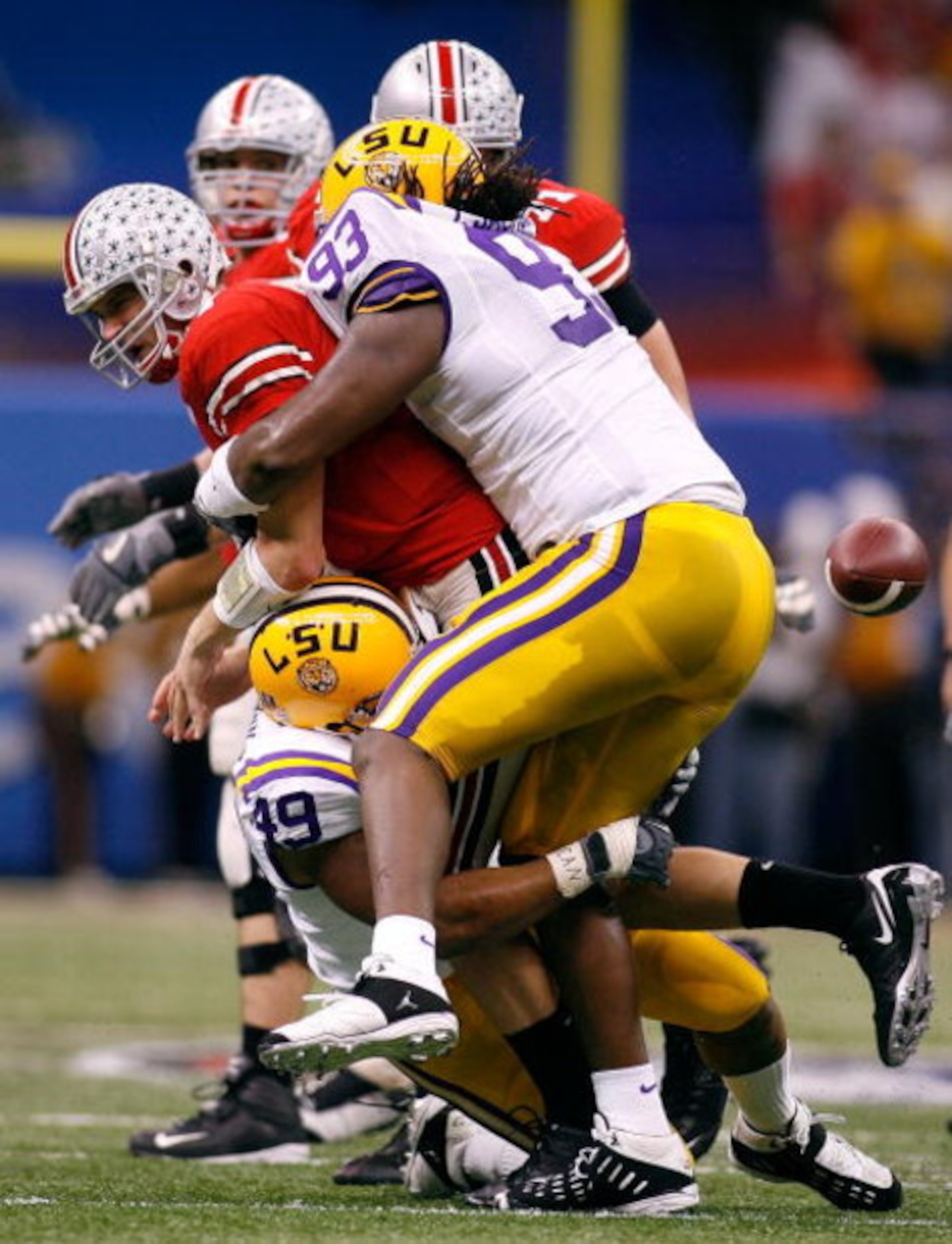 NEW ORLEANS - JANUARY 07:  Todd Boeckman #17 of the Ohio State Buckeyes loses the ball as he is wrapped by Tyson Jackson #93 of the Louisiana State University Tigers and Kirston Pittman #49 during the AllState BCS National Championship on January 7, 2008 