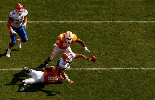 KNOXVILLE, TN - SEPTEMBER 20:  Tim Tebow #15 of the Florida Gators gets rid of the ball before teammates Robert Ayers #91 and Demonte Bolden #98 of the Tennessee Volunteers make a stop during their game at Neyland Stadium on September 20, 2008 in Knoxvill