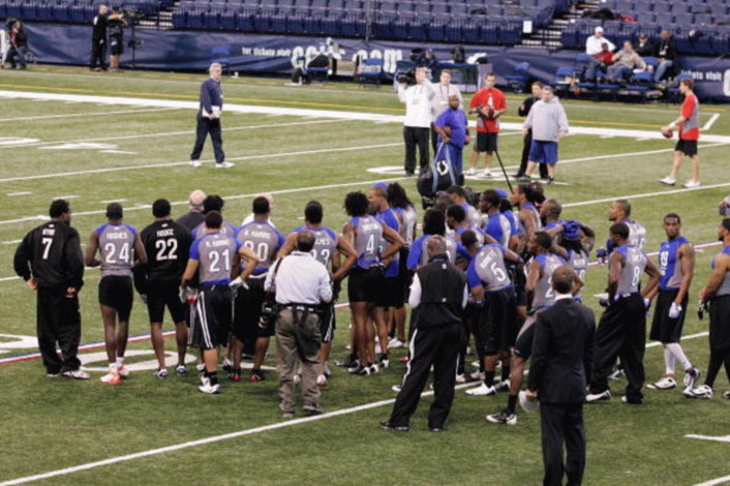 INDIANAPOLIS, IN - FEBRUARY 24:  Players huddle around an instructor as he explains a practice drill on the field during the NFL Scouting Combine presented by Under Armour at Lucas Oil Stadium on February 24, 2009 in Indianapolis, Indiana. (Photo by Scott