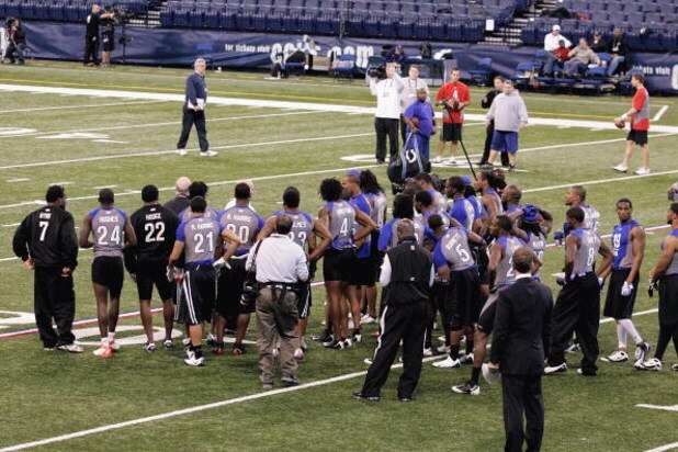 INDIANAPOLIS, IN - FEBRUARY 24:  Players huddle around an instructor as he explains a practice drill on the field during the NFL Scouting Combine presented by Under Armour at Lucas Oil Stadium on February 24, 2009 in Indianapolis, Indiana. (Photo by Scott