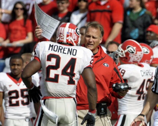 ORLANDO, FL - JANUARY 1: Running back Knowshon Moreno #24 of the University of Georgia talks with coach Mark Richt against the Michigan State Spartans during the 2009 Capital One Bowl at the Citrus Bowl on January 1, 2009 in Orlando, Florida.  (Photo by A