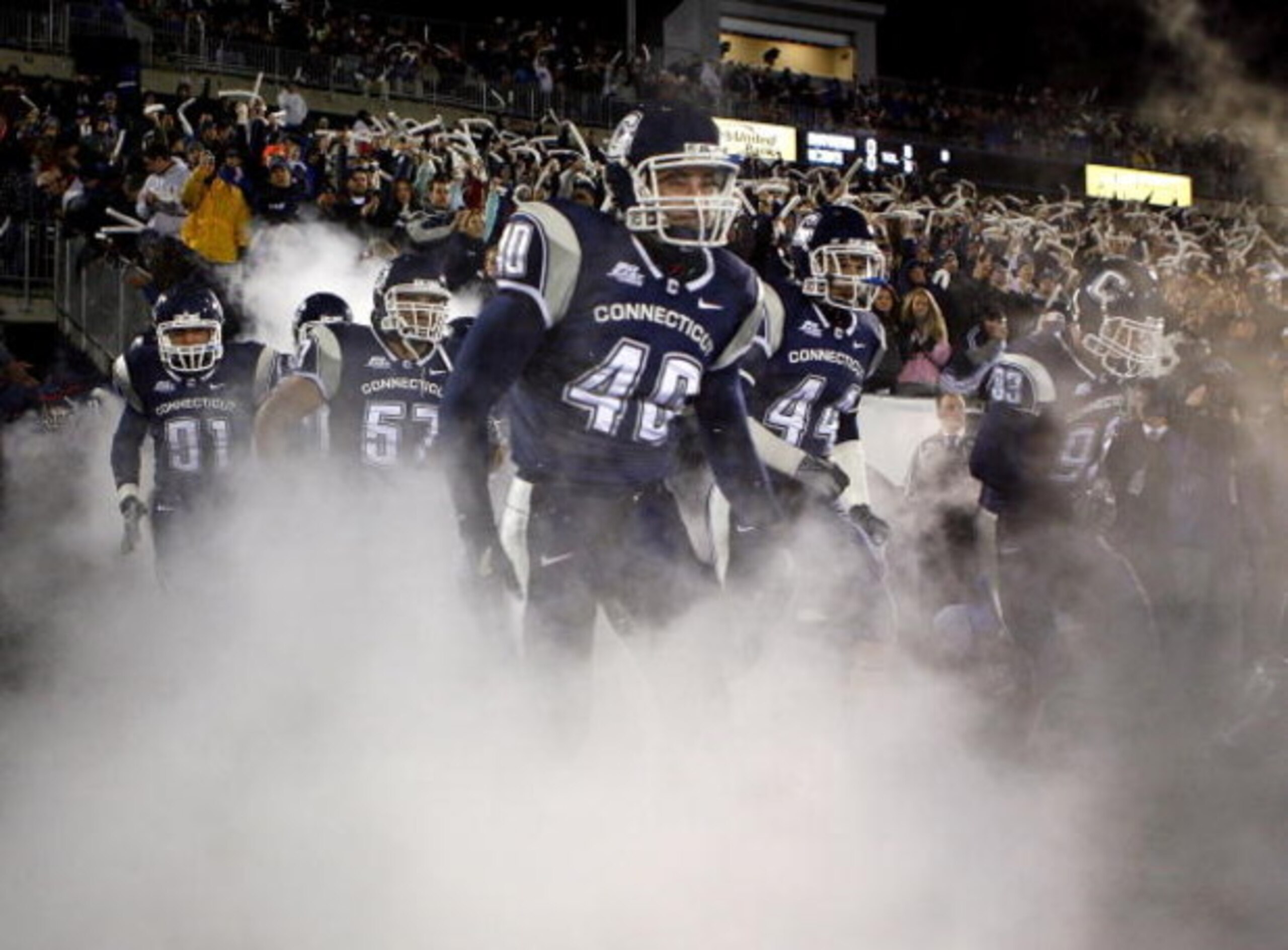 EAST HARTFORD, CT - NOVEMBER 3:  Members of the University of Connecticut Huskies run onto the field against the Rutgers Scarlet Knights at Rentschler Field November 3, 2007 in East Hartford, Connecticut.  (Photo by Jim Rogash/Getty Images)