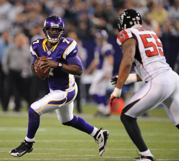 MINNEAPOLIS - DECEMBER 21:  Tarvaris Jackson #7  of the Minnesota Vikings scrambles under pressure from John Abraham #55 of the Atlanta Falcons during an NFL game at the Hubert H. Humphrey Metrodome, on December 21, 2008 in Minneapolis, Minnesota.  (Photo