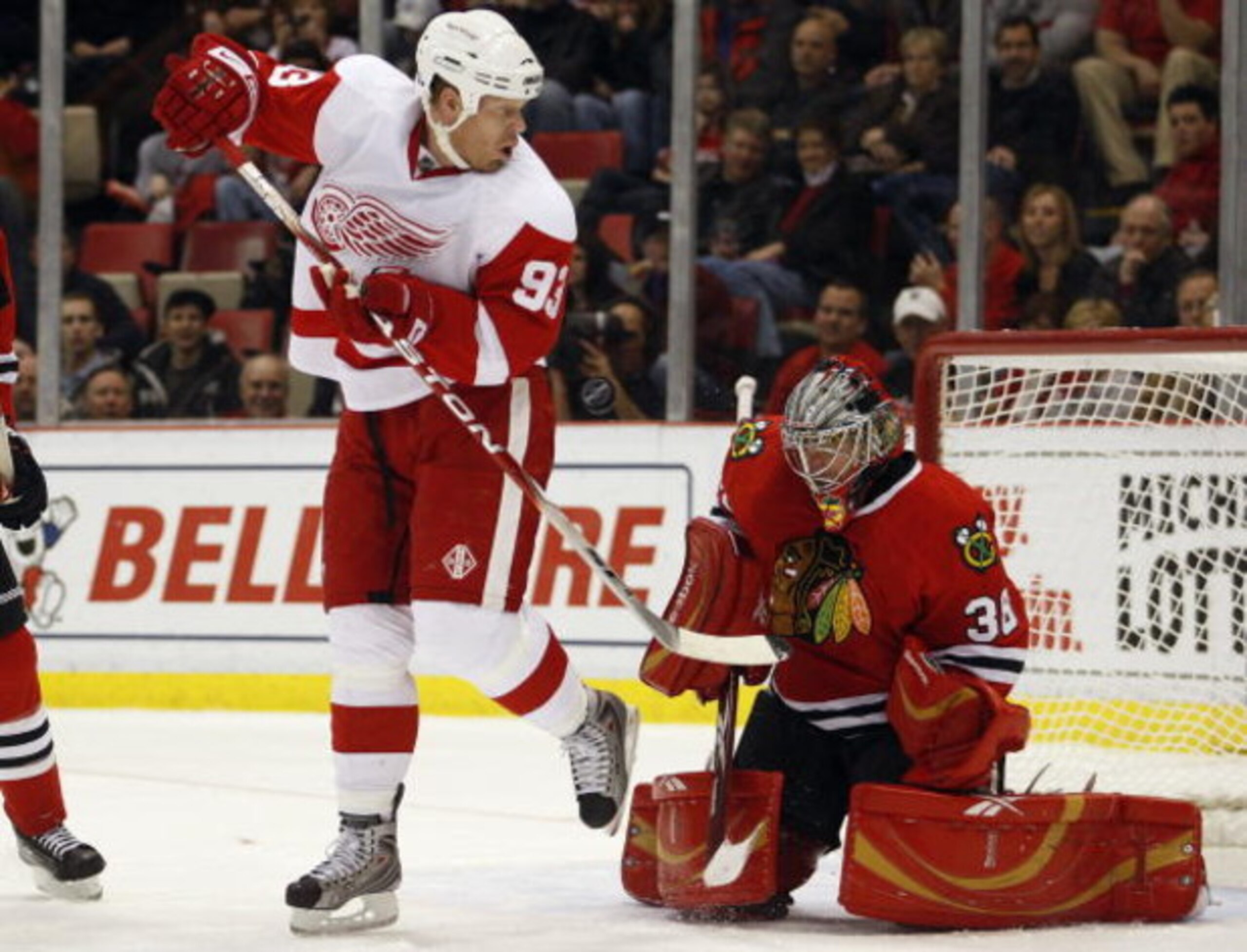 DETROIT, MI - DECEMBER 6: Johan Franzen #93 of the Detroit Red Wings tips a shot at Cristobal Huet #38 of the Chicago Blackhawks in a game on December 6, 2008 at the Joe Louis Arena in Detroit, Michigan. The Wings defeated the Hawks 5-4 in a overtime shoo